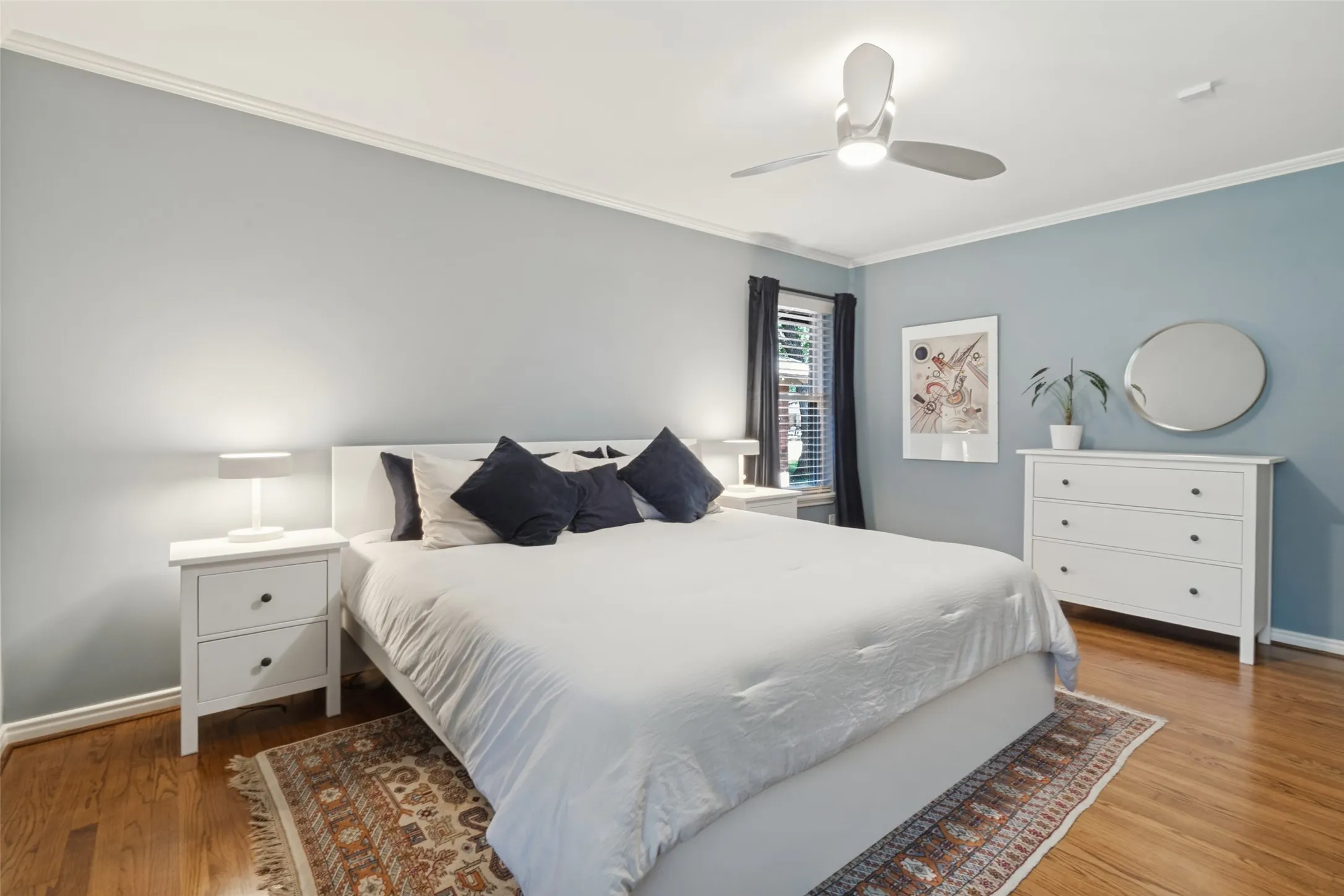 Original Hardwood floors, crown molding, ceiling fan with integrated lighting, and window with blinds