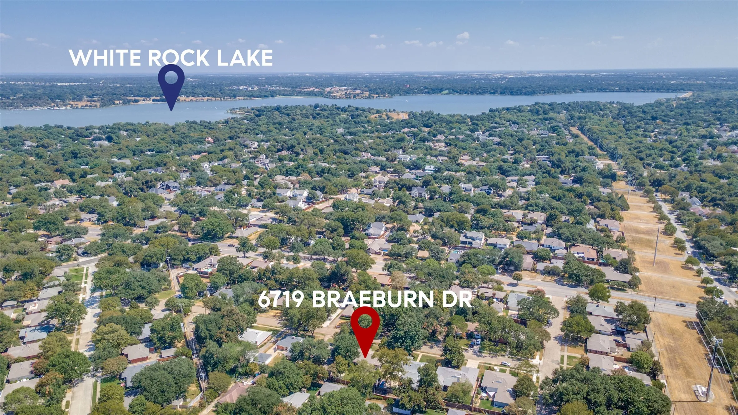 Aerial perspective showcasing a residential neighborhood with mature trees and proximity to White Rock Lake