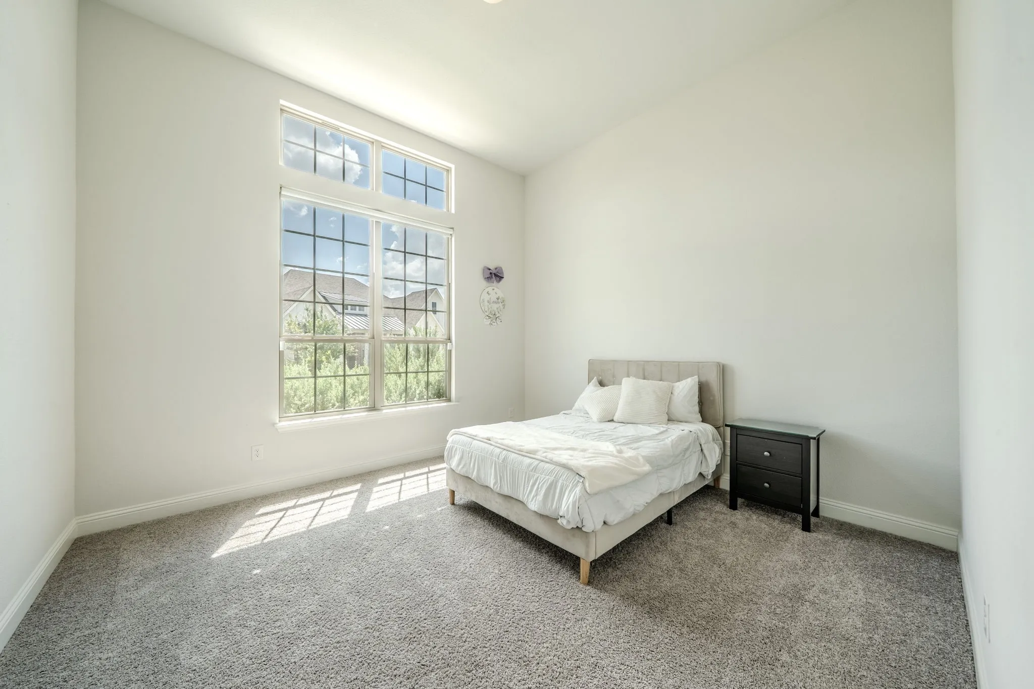 High ceilings and a multi-pane window with transom accents