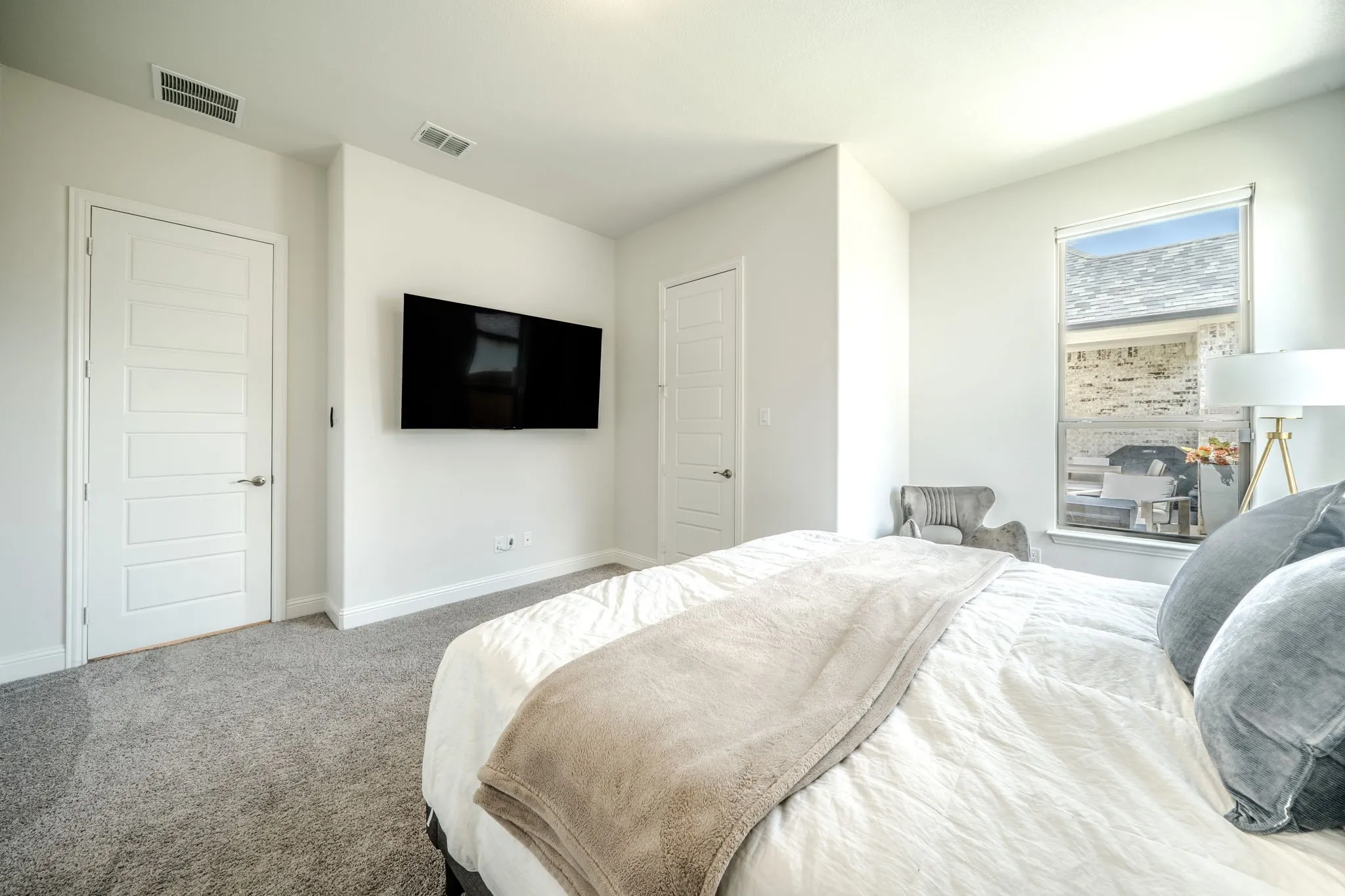 Carpeted flooring, white interior doors, and a window with blinds