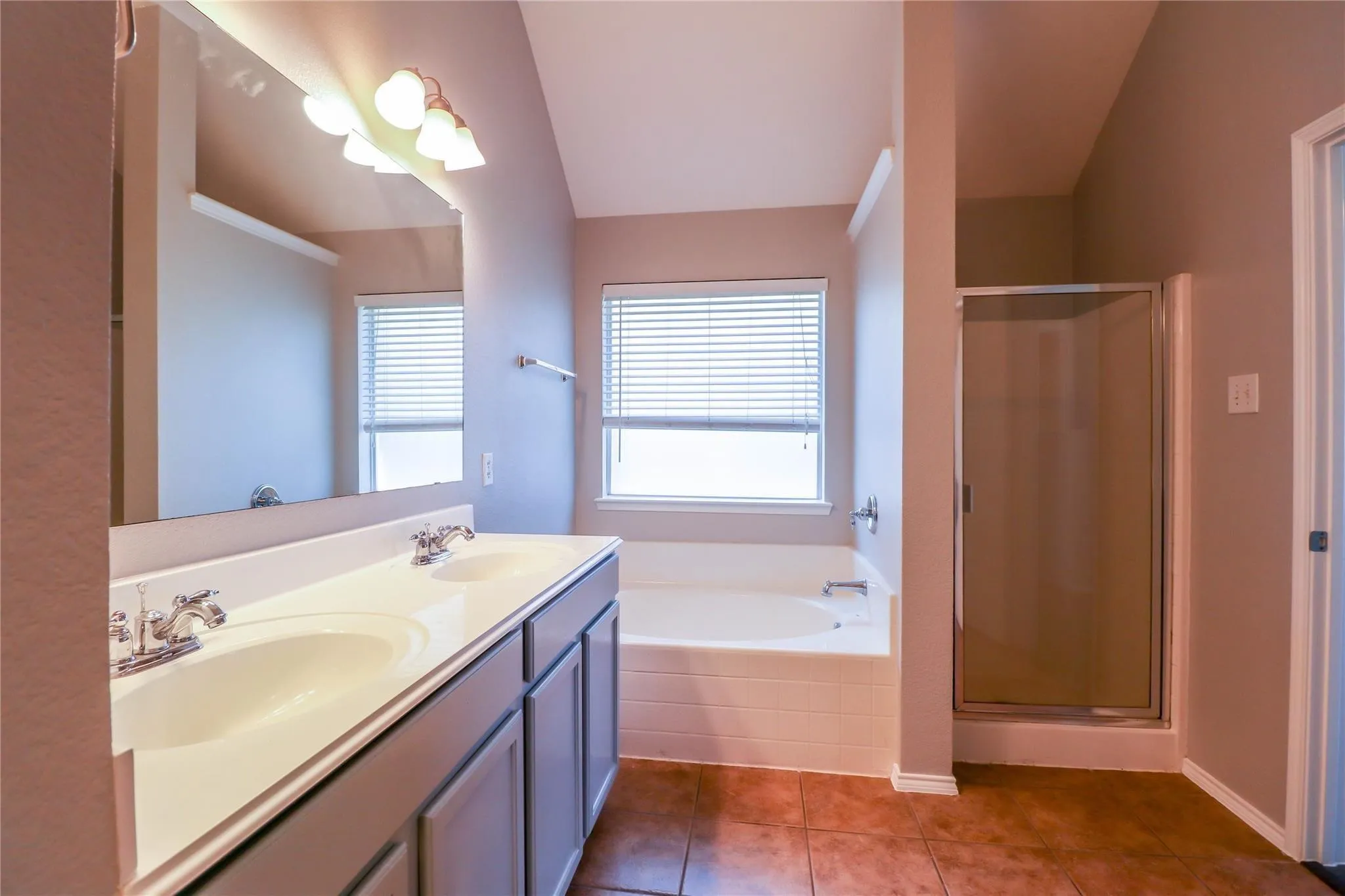 Dual vanity with integrated sinks, framed mirror, and chrome fixtures