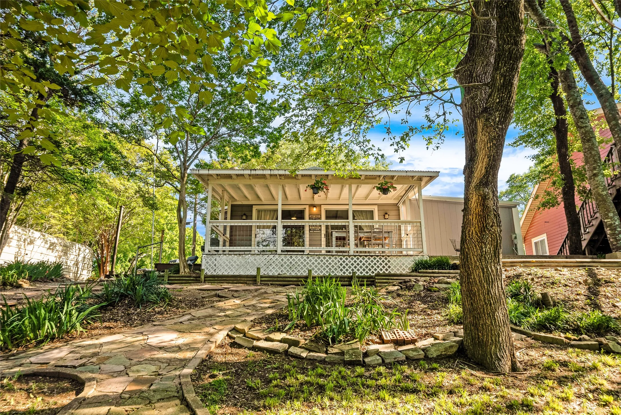 Covered front porch with white railings and lattice detailing