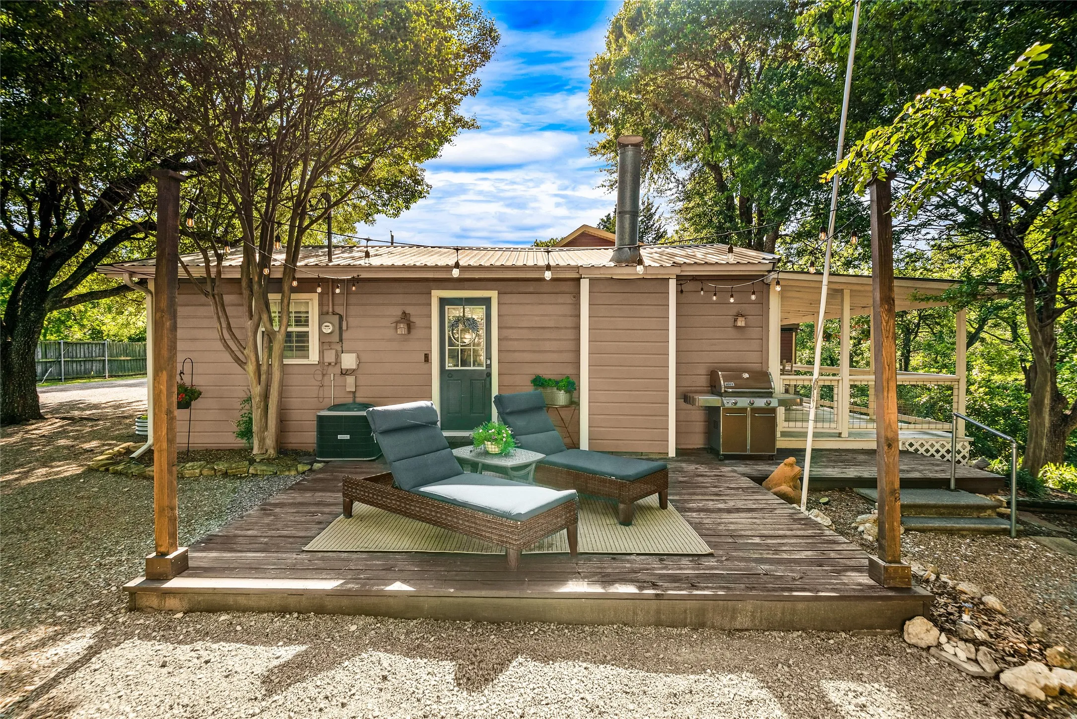 Exterior featuring a corrugated metal roof, wood siding, and an outdoor deck