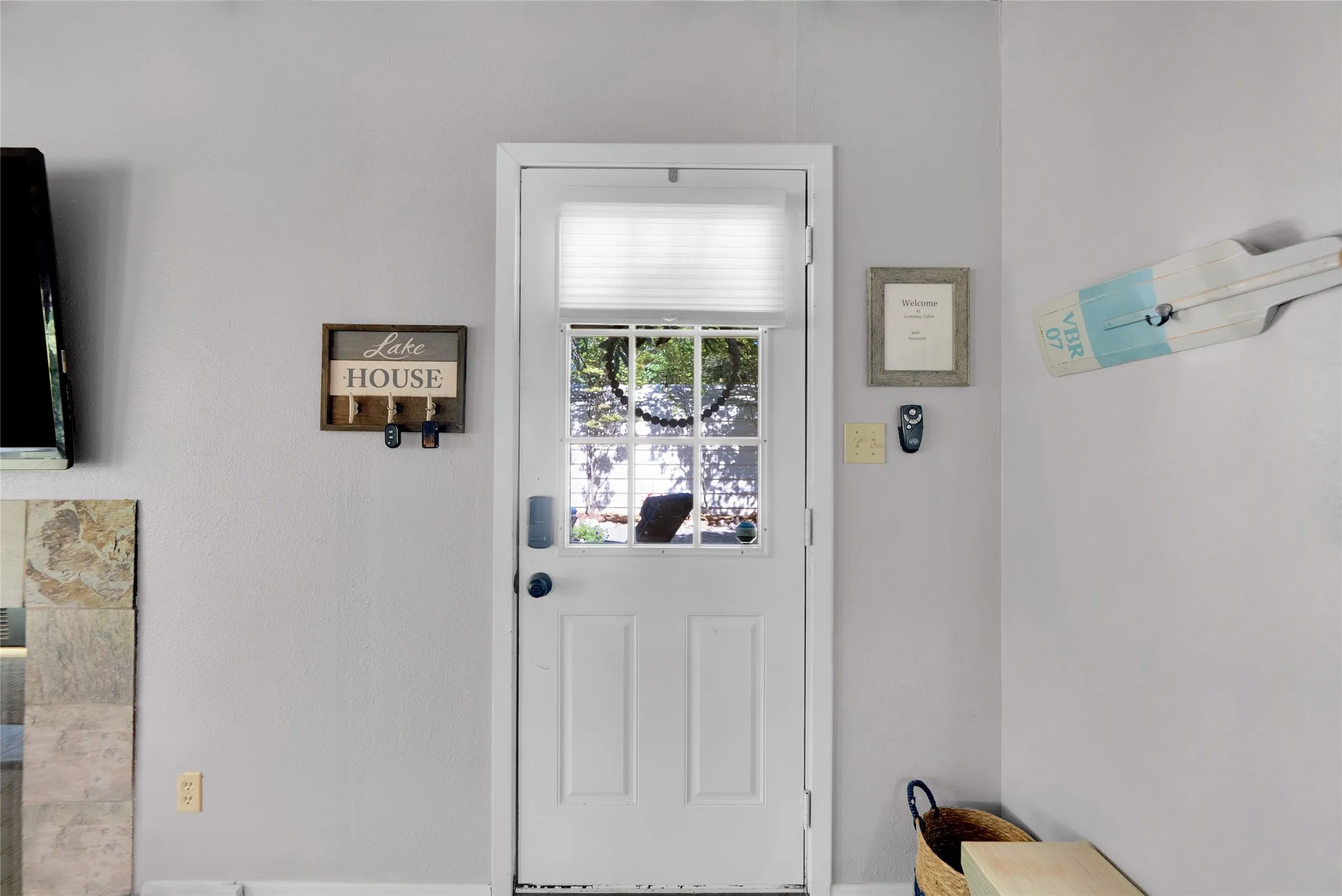 White paneled exterior door with window insert, equipped with a digital lock and privacy blind