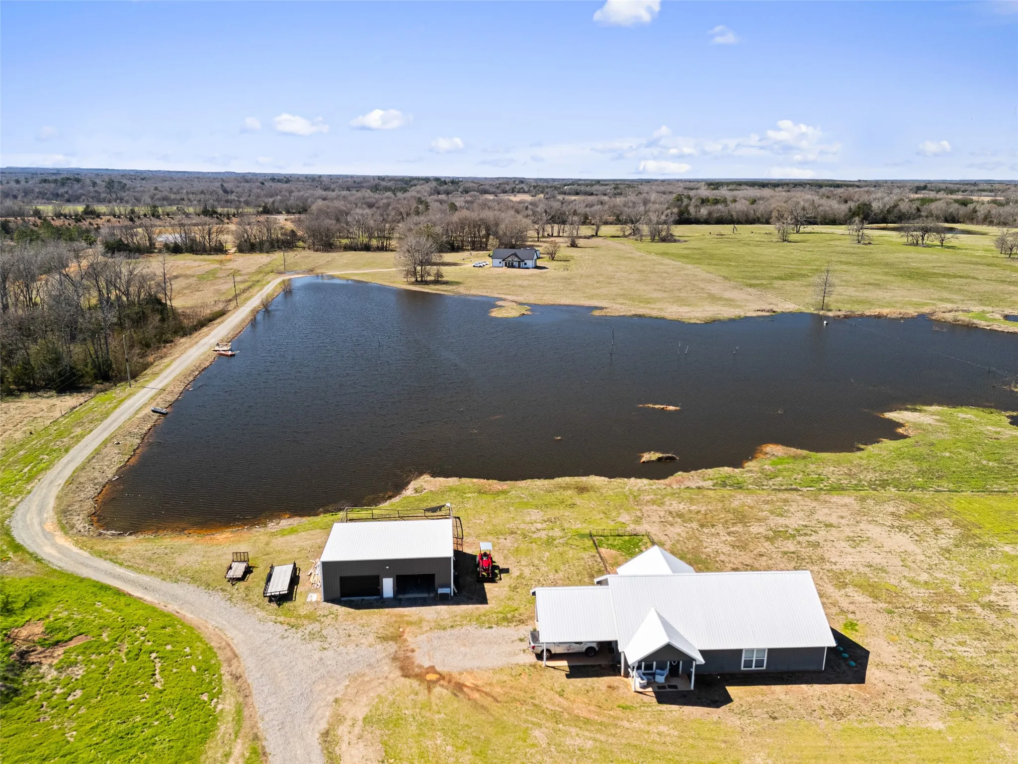 Birds eye view of property with a water view