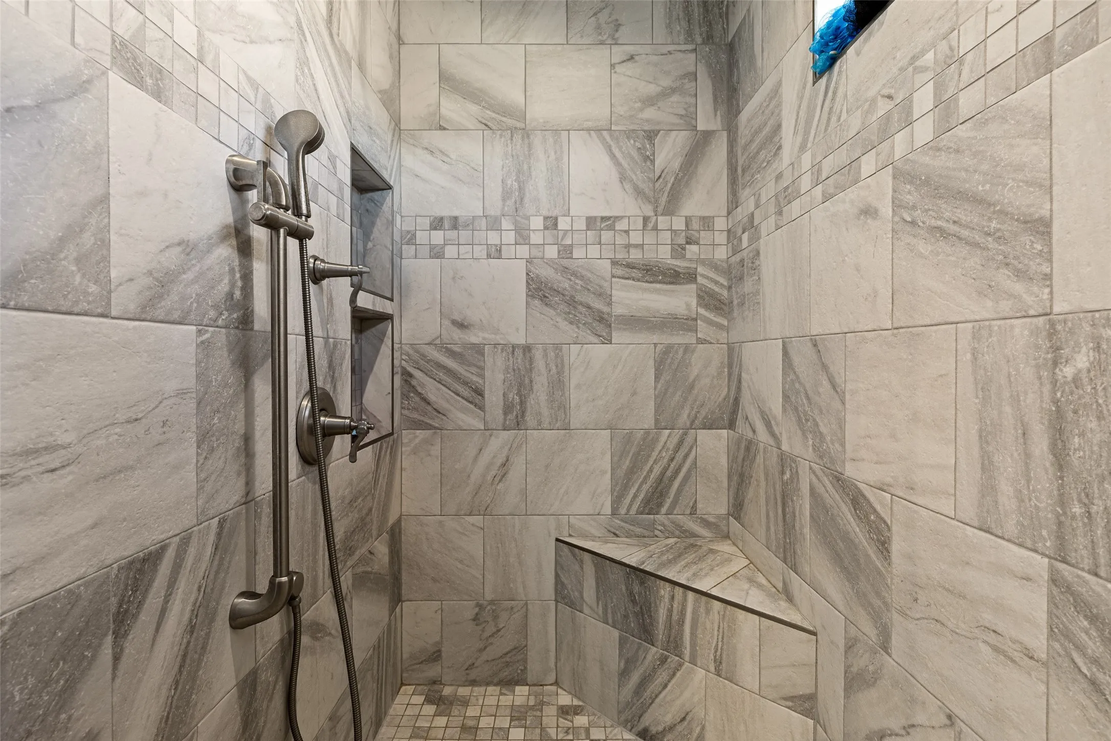 Room details featuring a tile shower