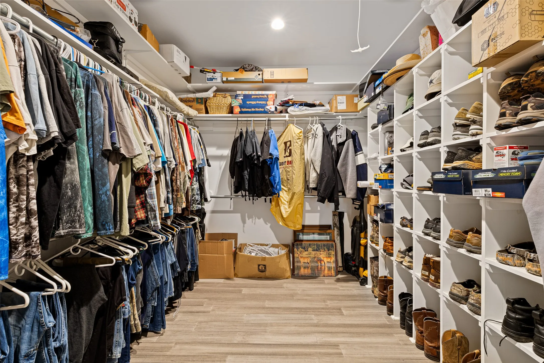 Spacious closet with light hardwood / wood-style flooring