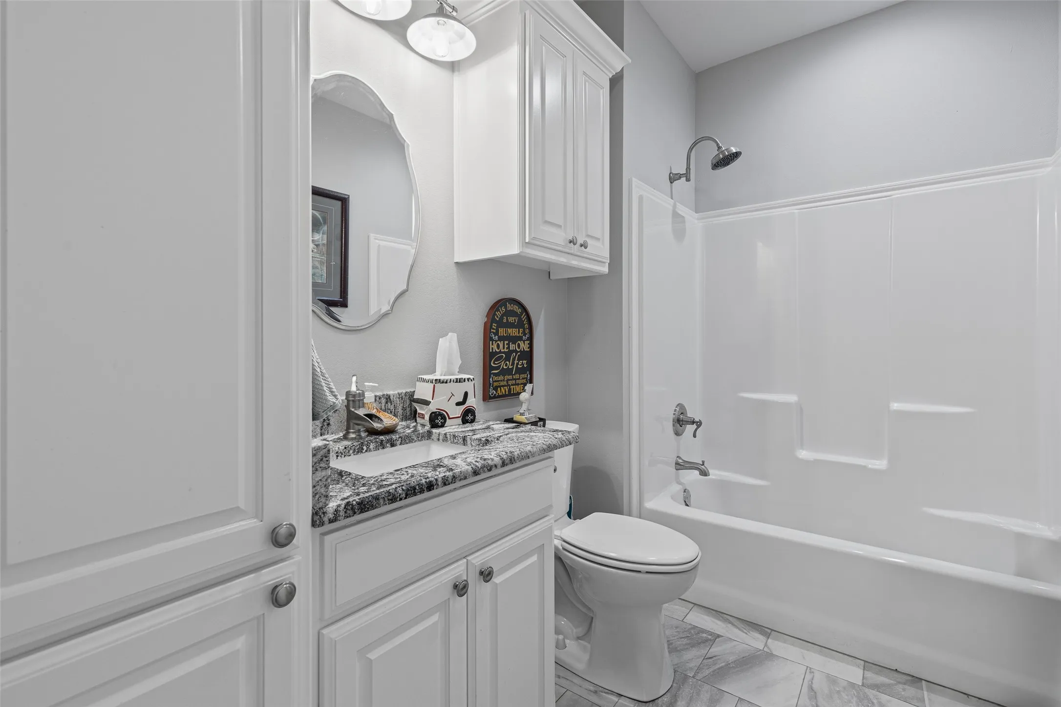 Full bathroom featuring toilet, vanity, and bathtub / shower combination