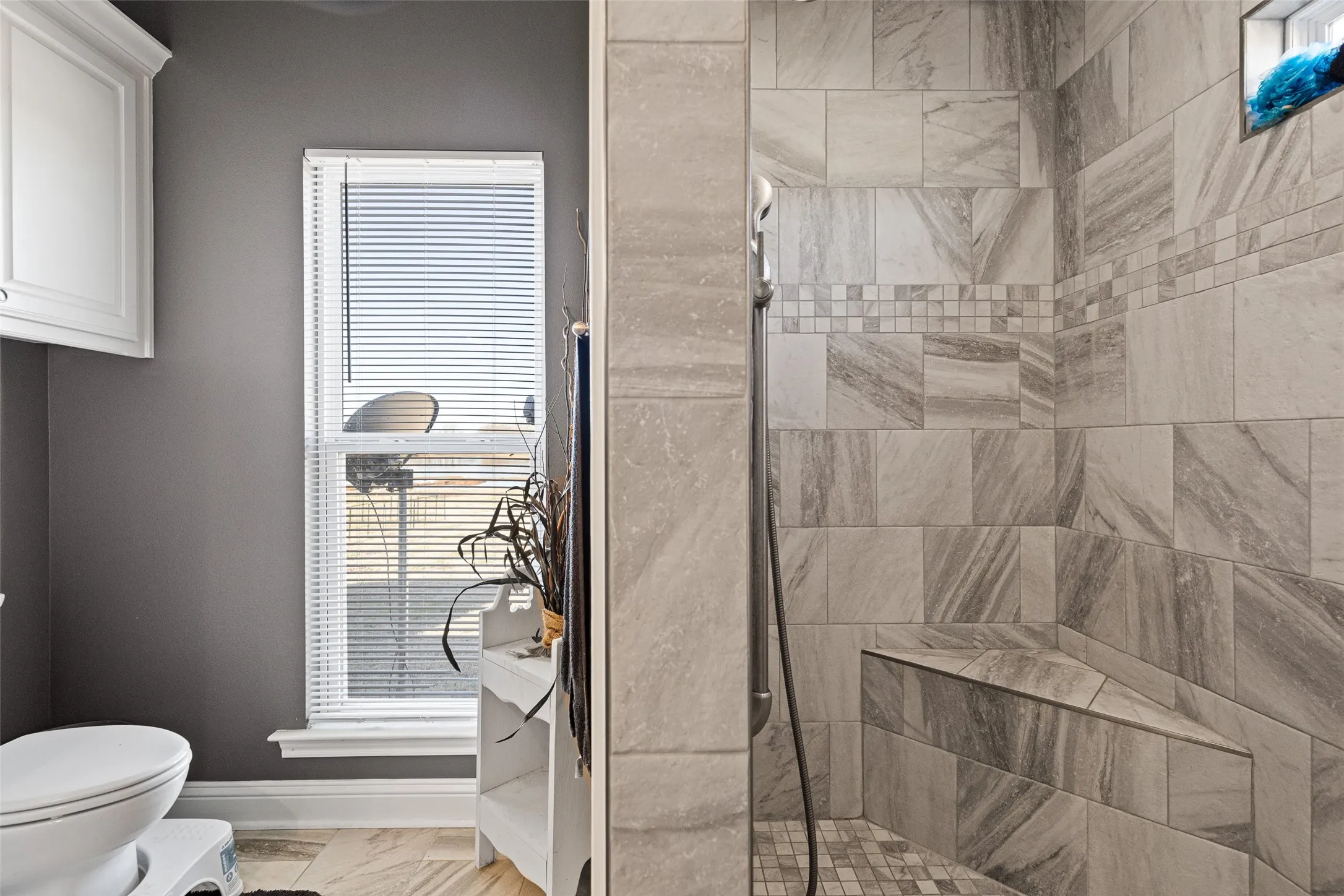 Bathroom with a tile shower and toilet