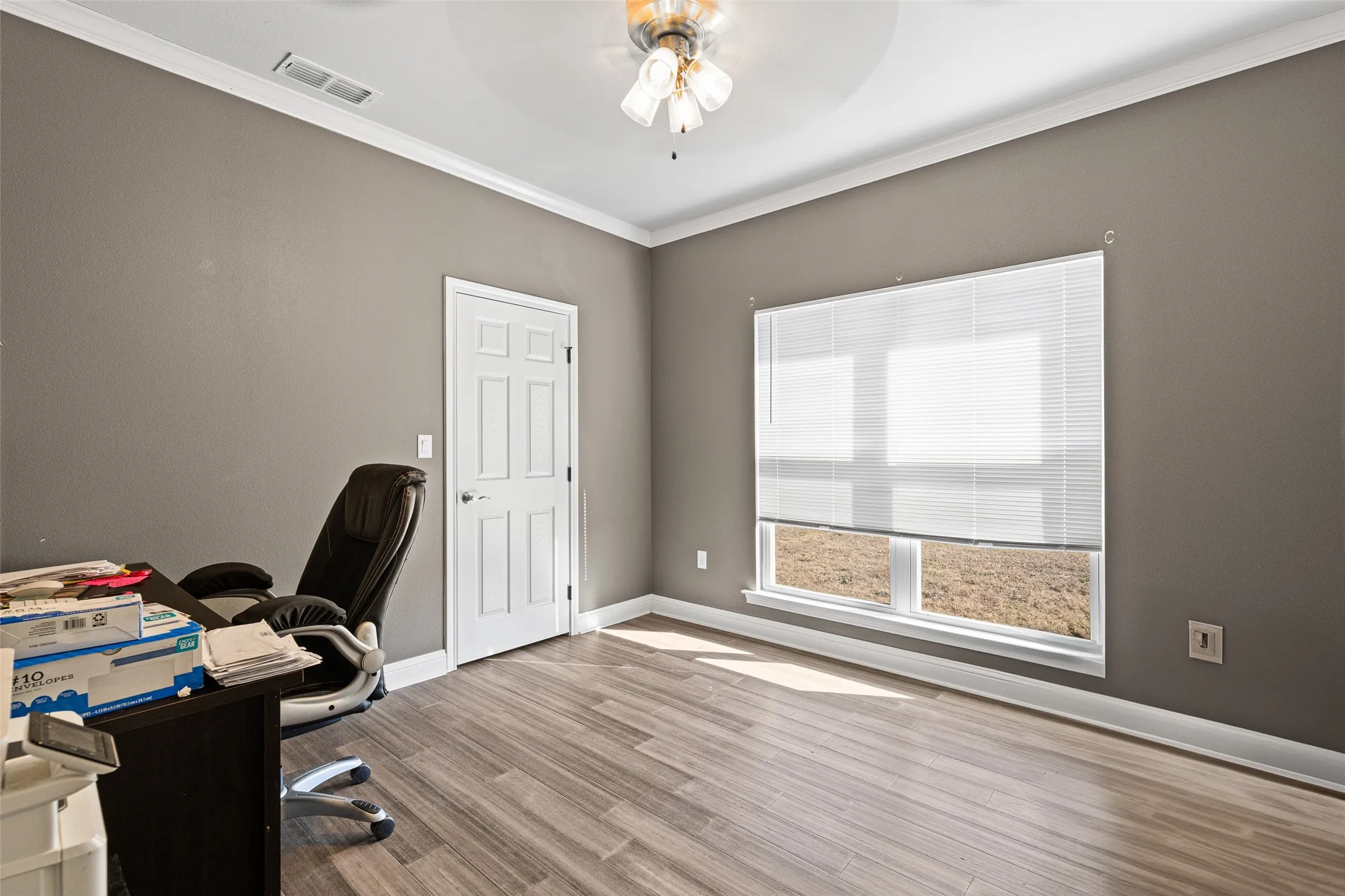 Office featuring hardwood / wood-style floors, ornamental molding, and ceiling fan
