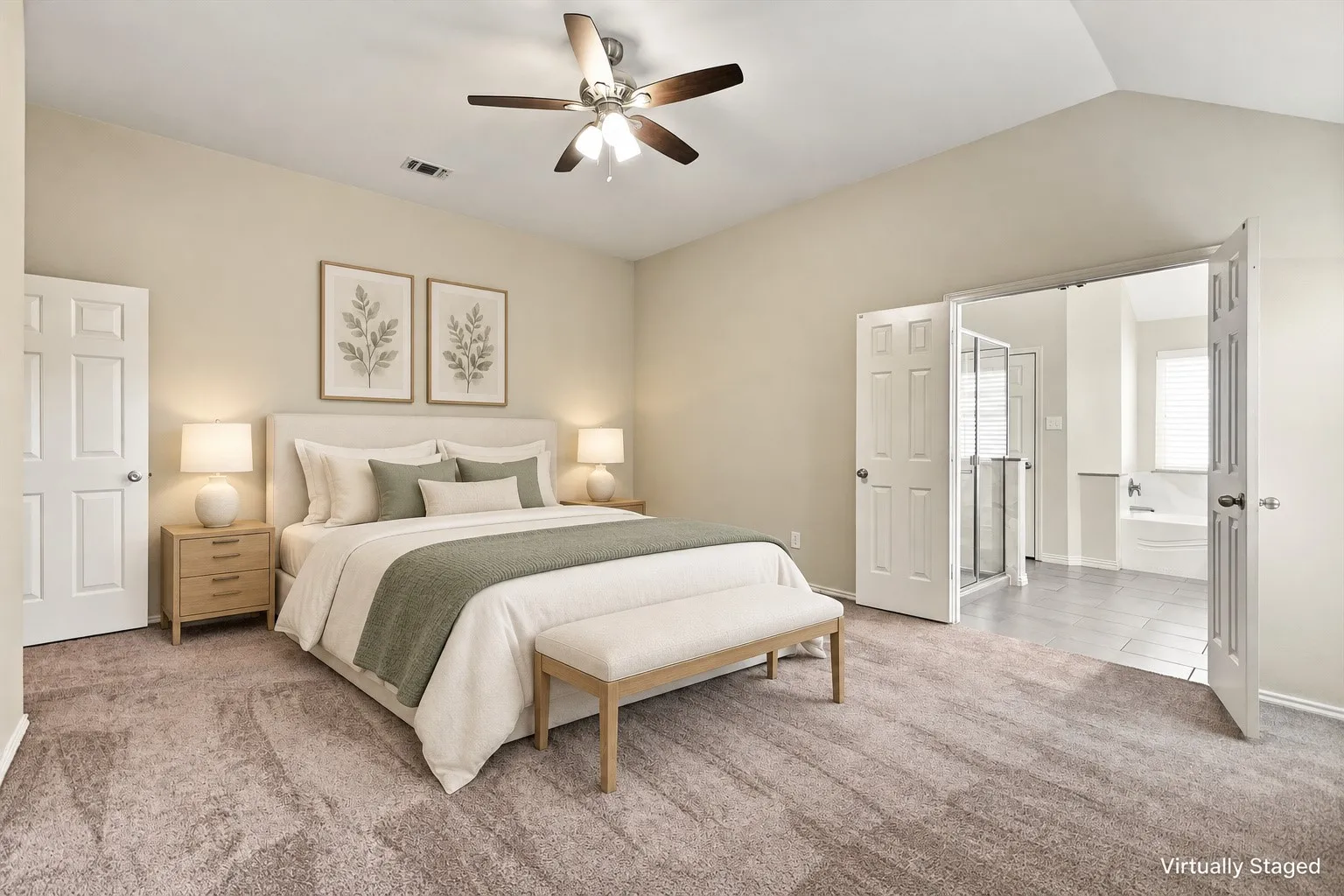 Vaulted ceiling with a ceiling fan, carpeted flooring, and double doors opening to a bathroom with a glass-enclosed shower and built-in tub