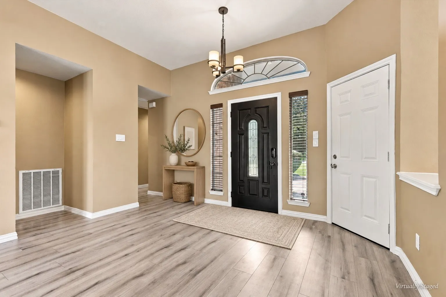 Light wood-finish flooring complements neutral wall tones