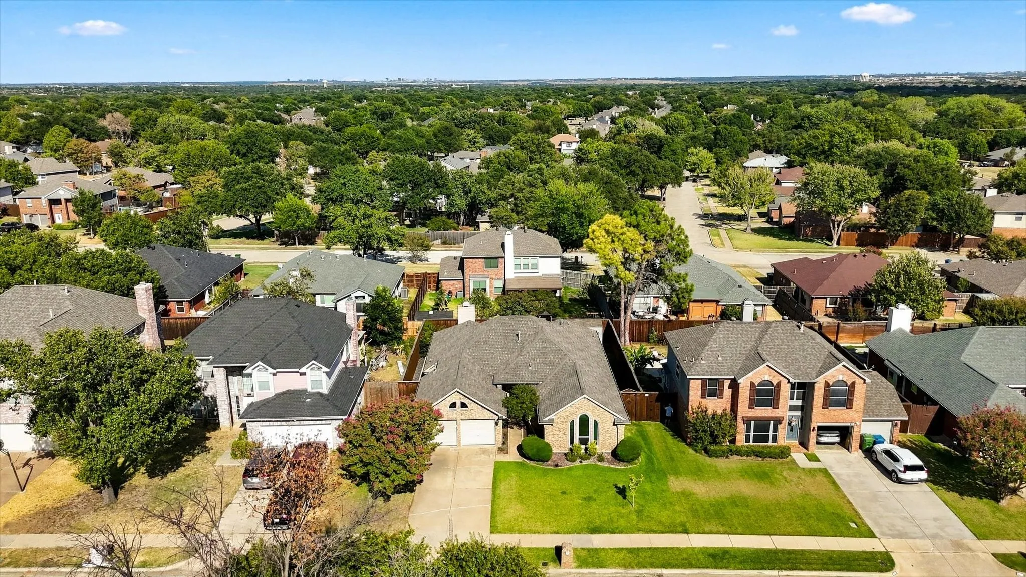 Expansive residential area featuring numerous properties with mature trees and paved streets