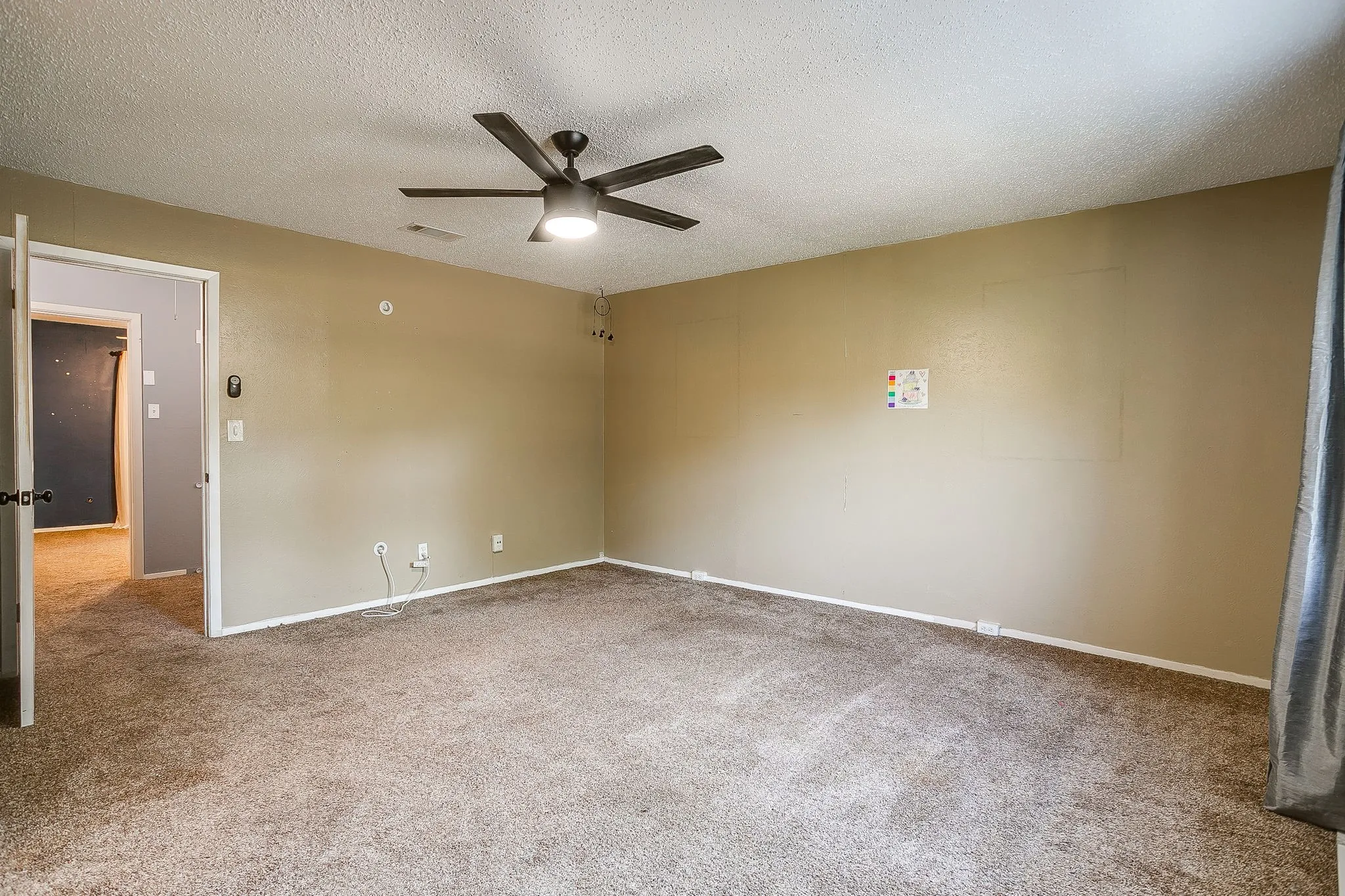 Carpeted flooring, neutral wall color, ceiling fan with integrated lighting, and white trim