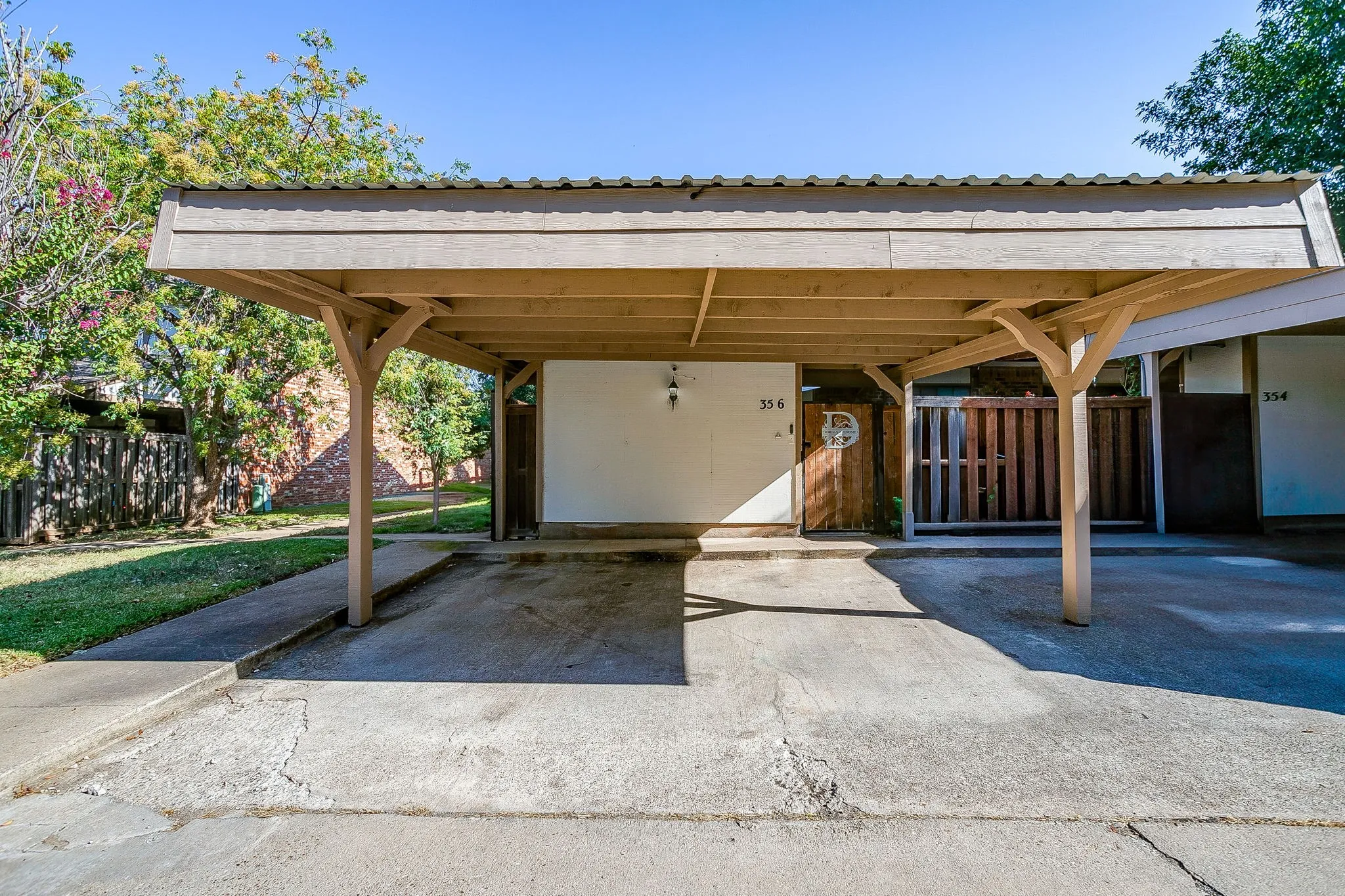Covered carport with wood supports and a metal roof