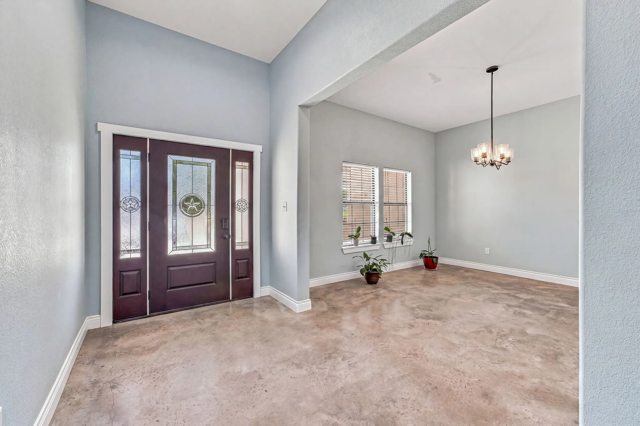 Entryway featuring a dark wood-finish door with decorative glass inserts and sidelights