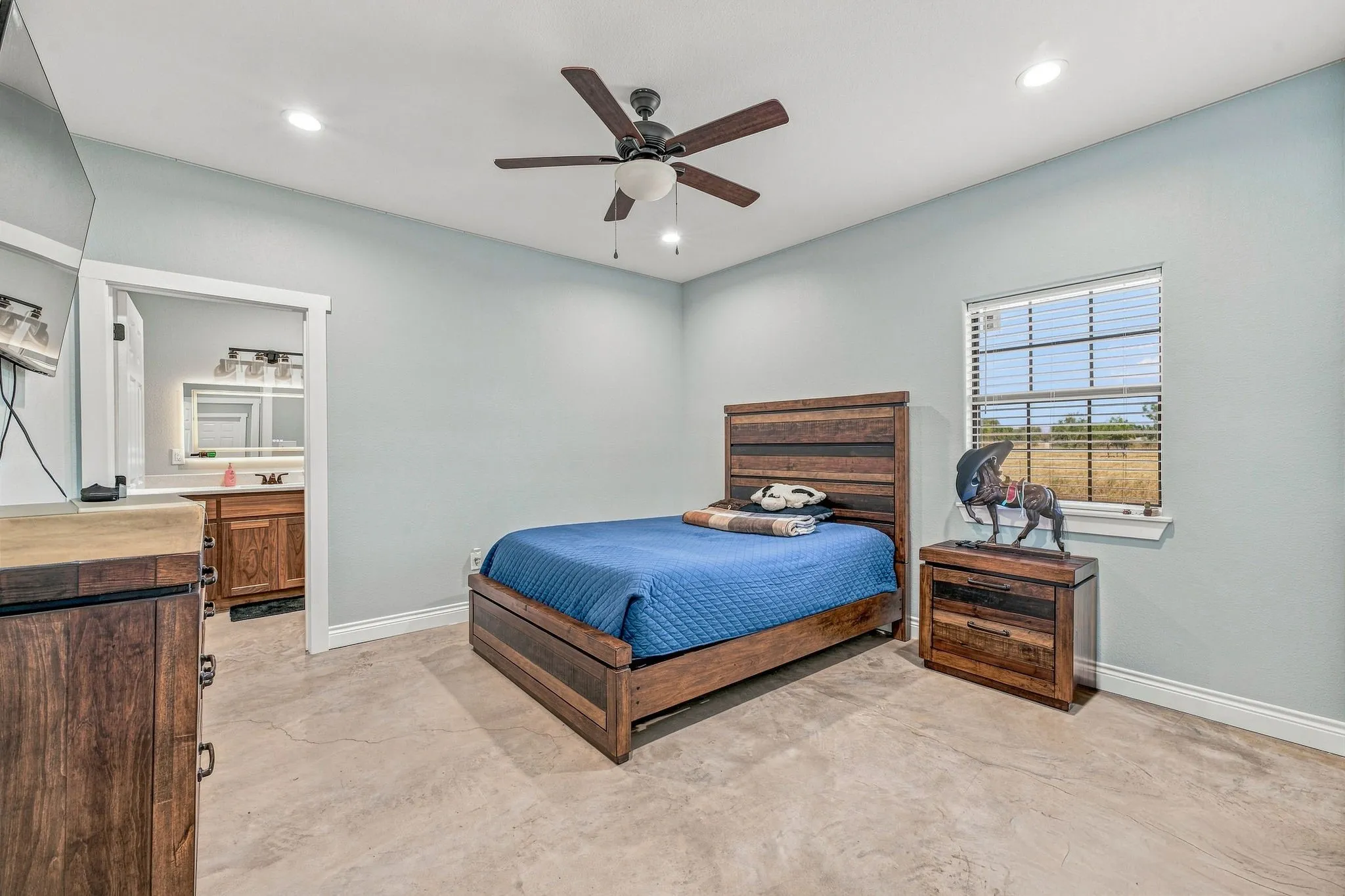 Recessed lighting, ceiling fan, hard-surface flooring, window with blinds, and an attached bathroom with vanity