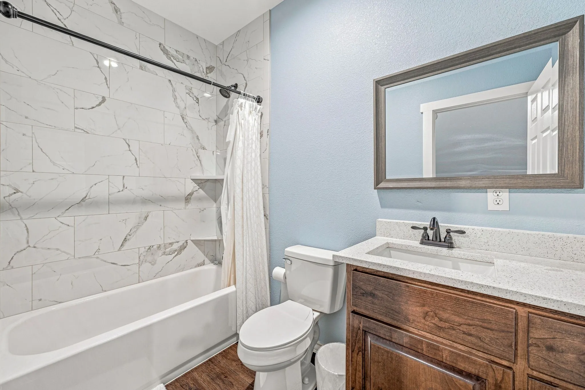 Bathtub and shower combination with tile surround and integrated shelving