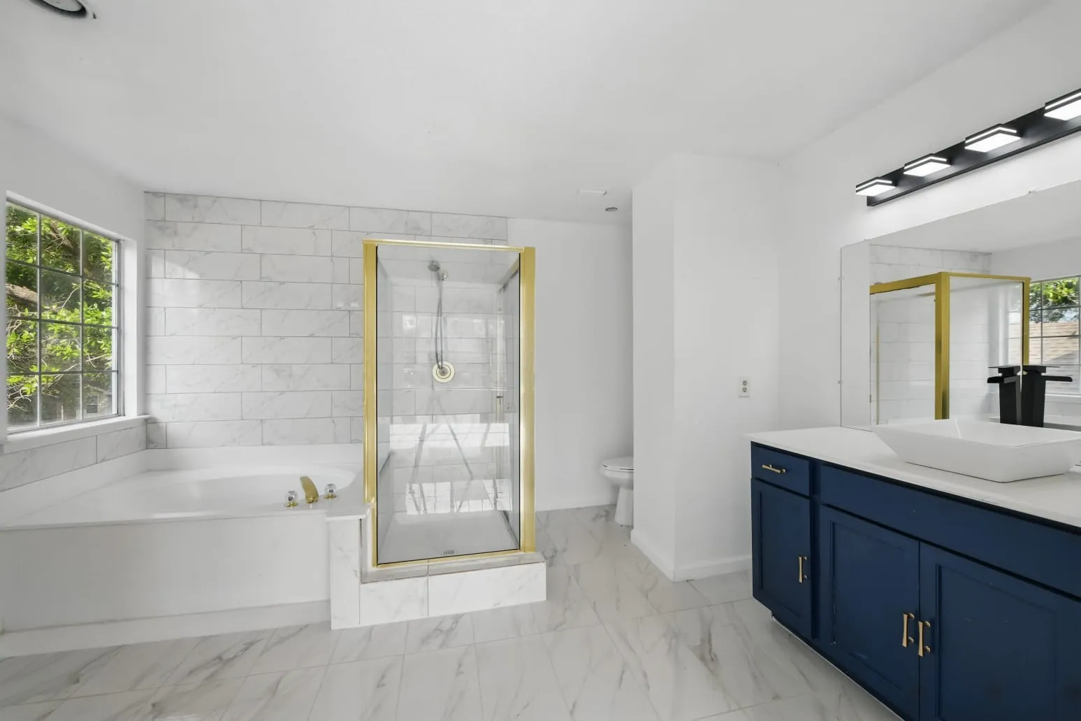 Bathroom with vanity, a stall shower, a bath, and marble look tile flooring