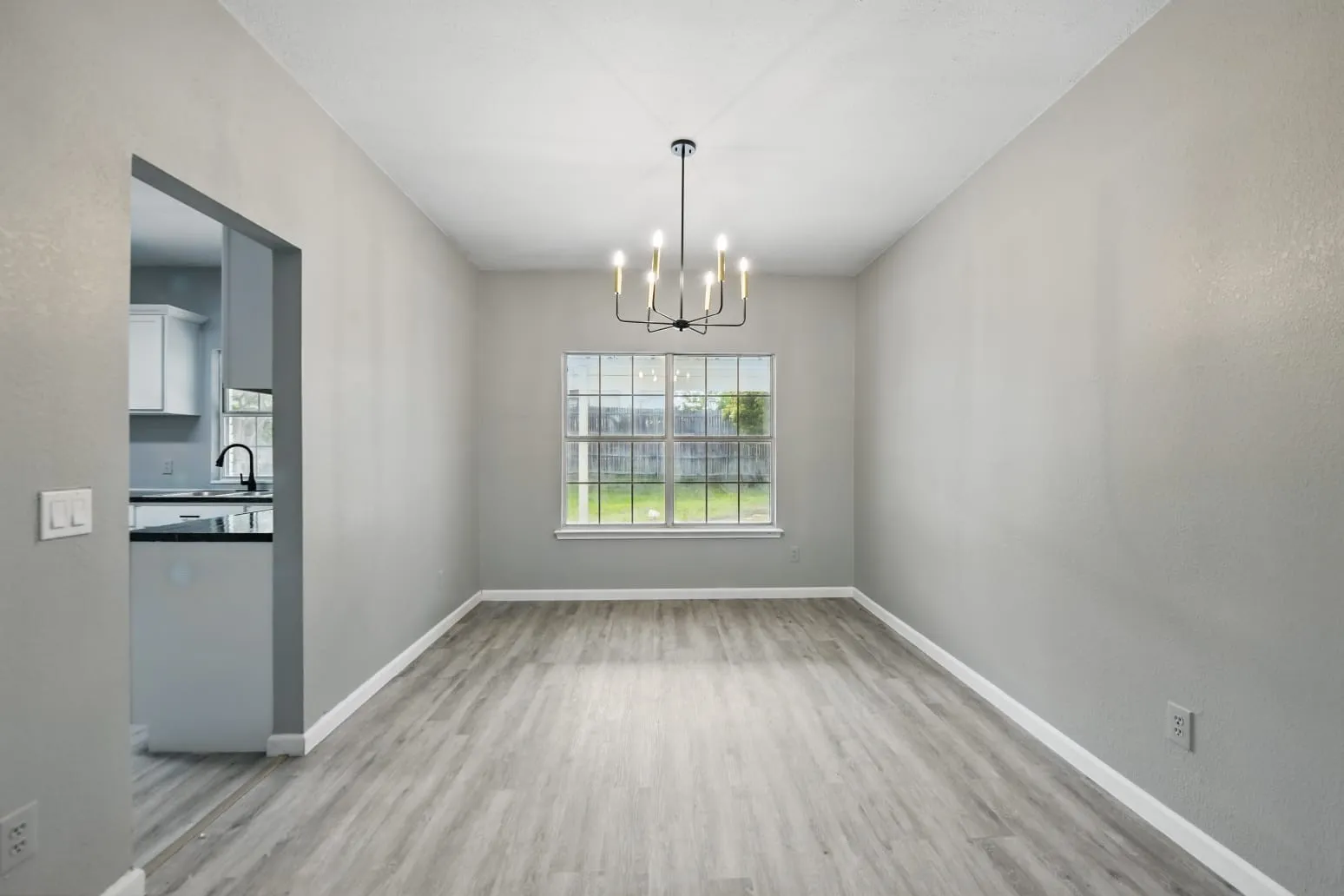 Unfurnished dining area featuring a chandelier and light wood finished floors