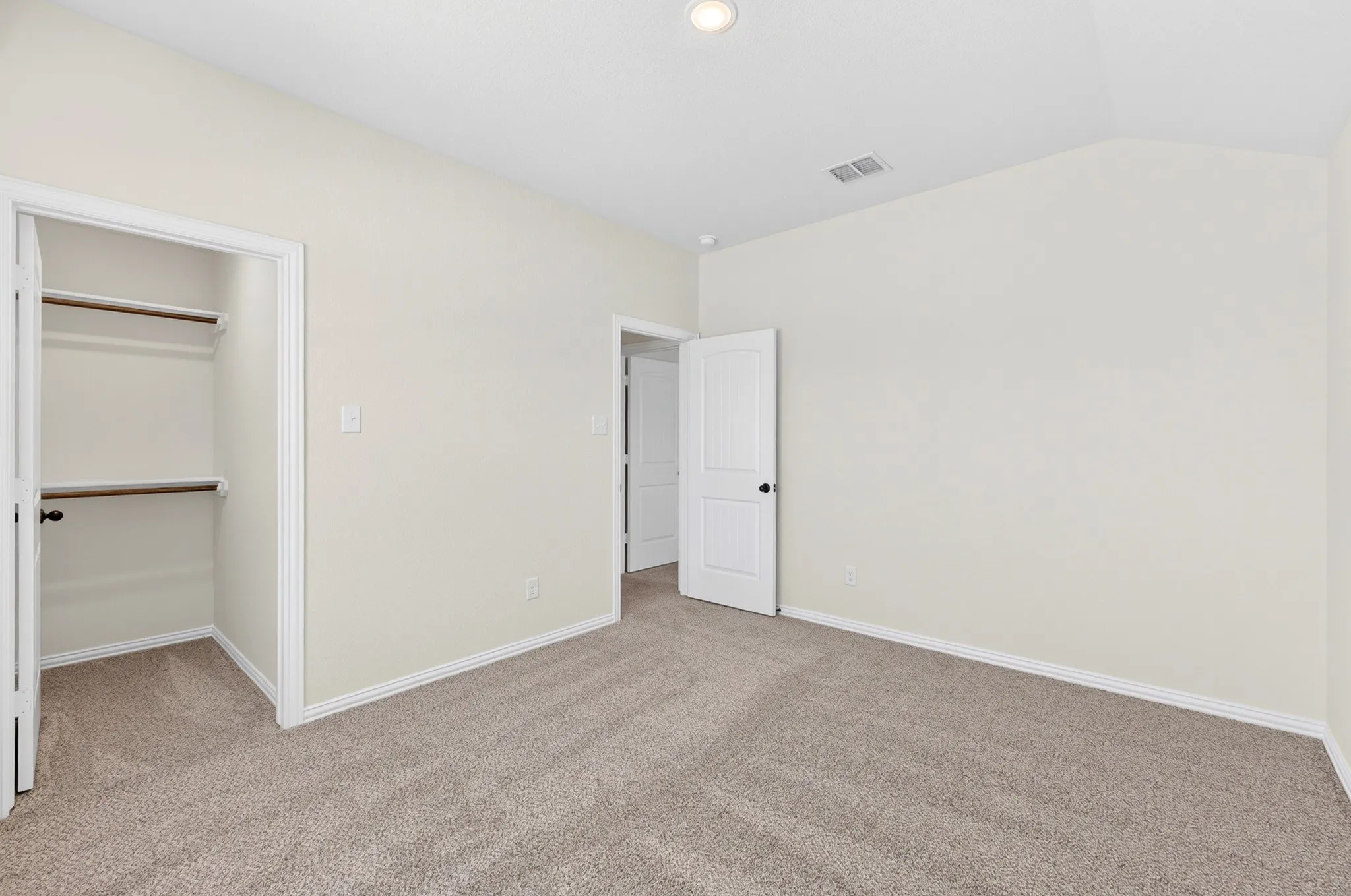 Neutral-toned carpeting with light-colored walls and white trim