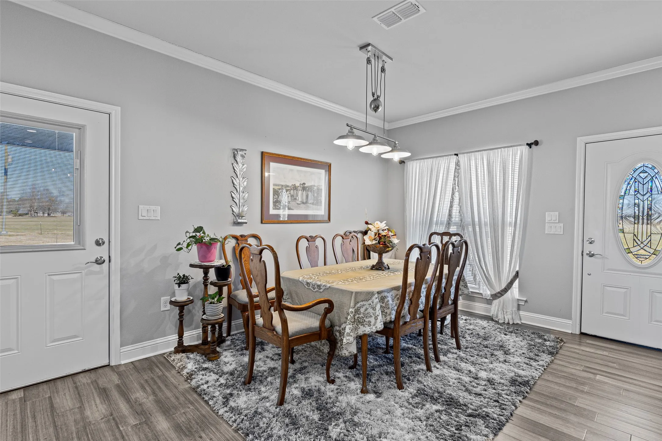 Dining area featuring light hardwood / wood-style flooring and ornamental molding