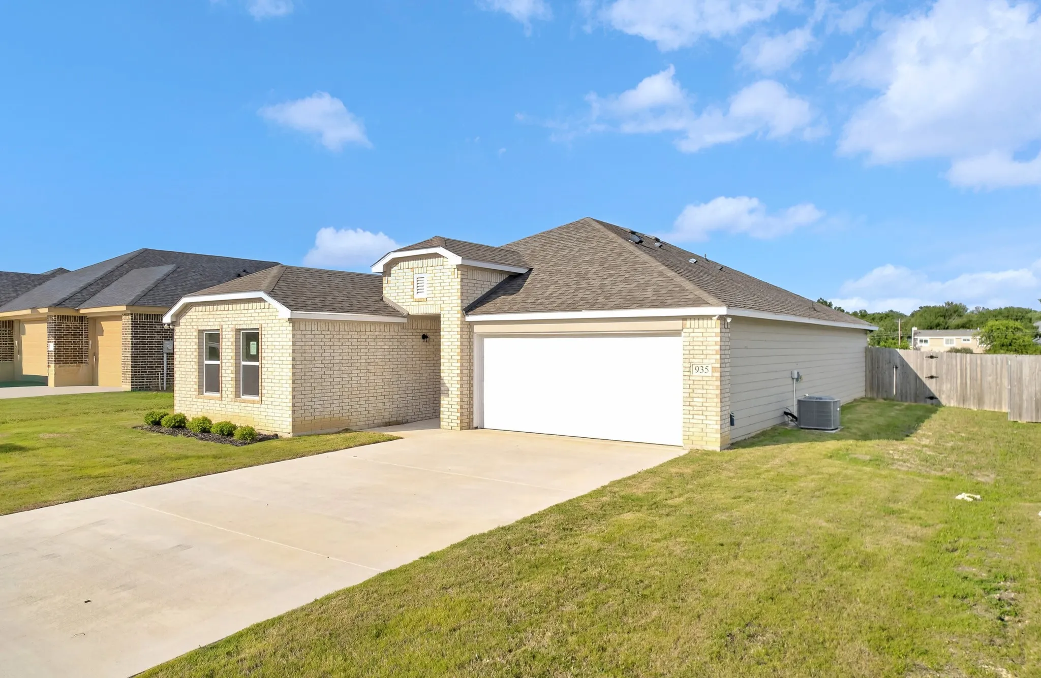 Single-story residence featuring a brick exterior and an attached two-car garage
