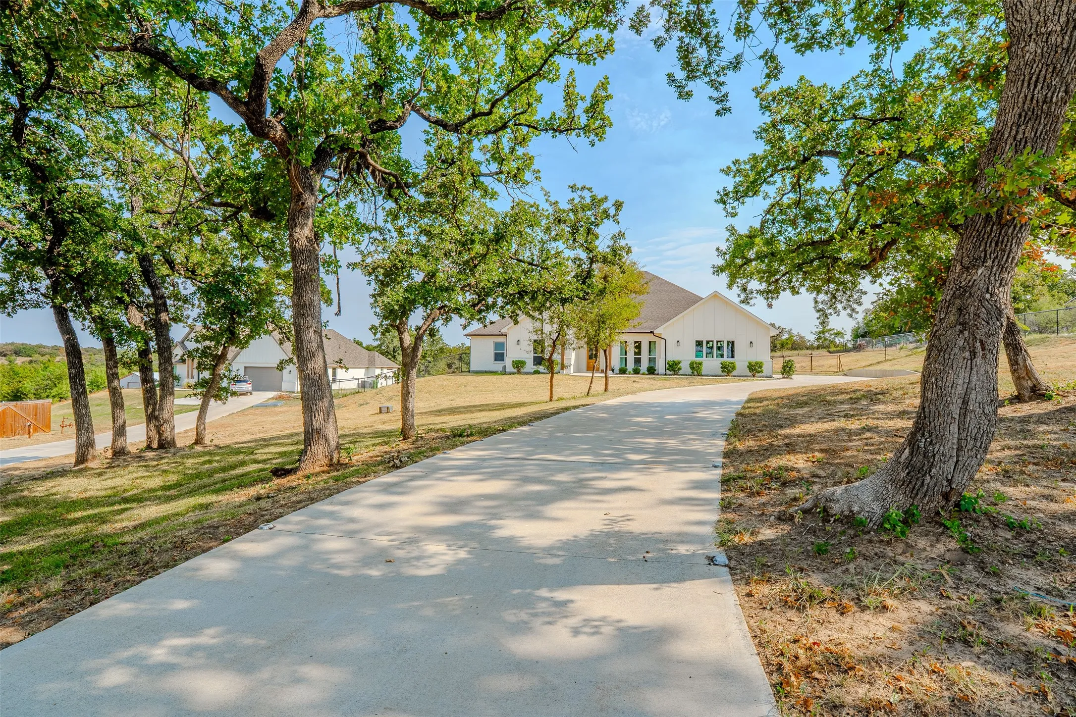 The long and winding driveway weaves through the trees that frame the home upon arrival.