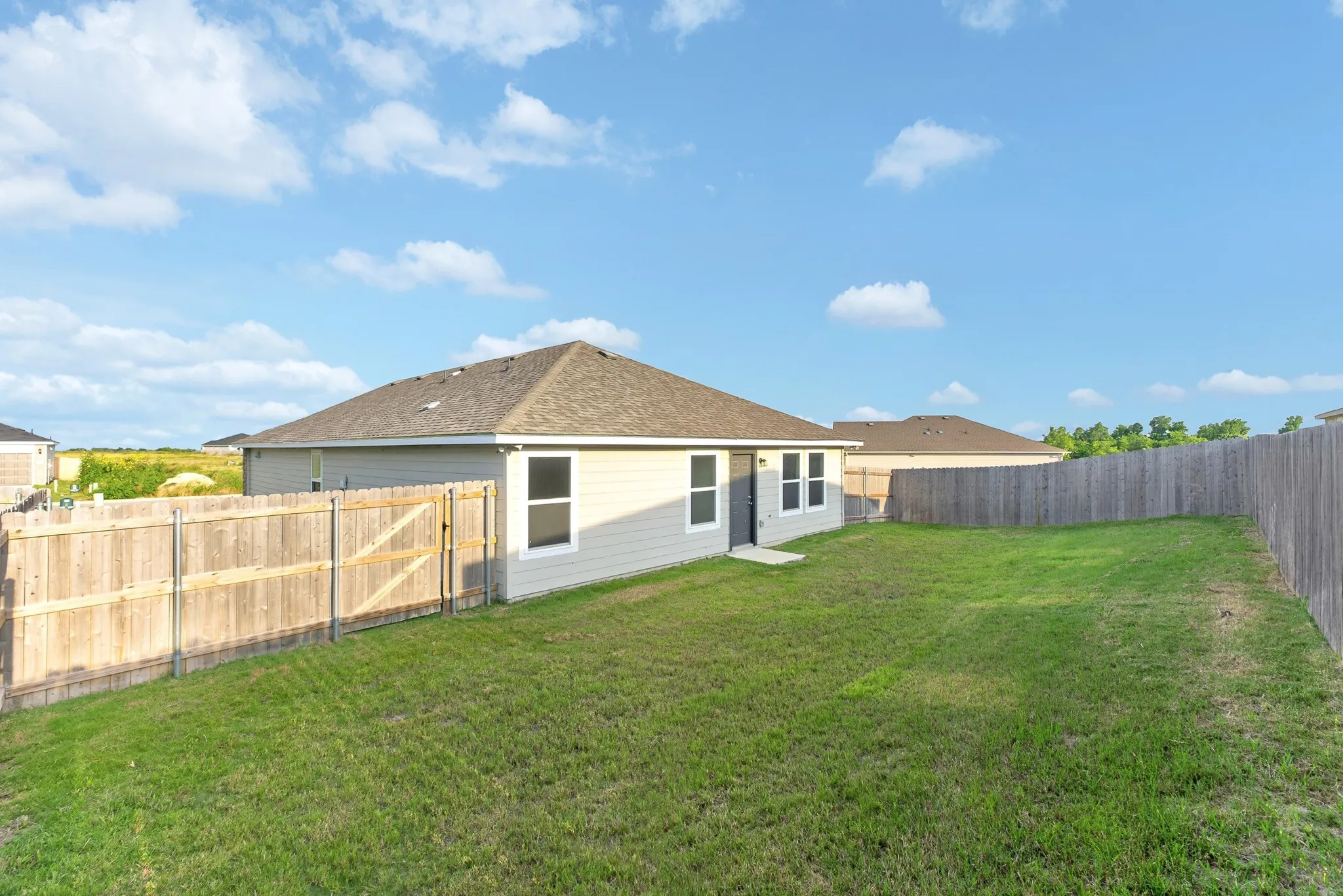 Spacious single-story residence with a hipped roof and modern exterior finishes, situated on an expansive lot with mature landscaping