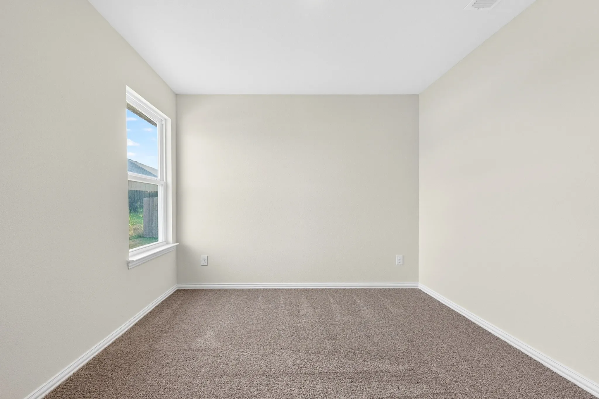 White window trim, light neutral wall color, and carpeted flooring