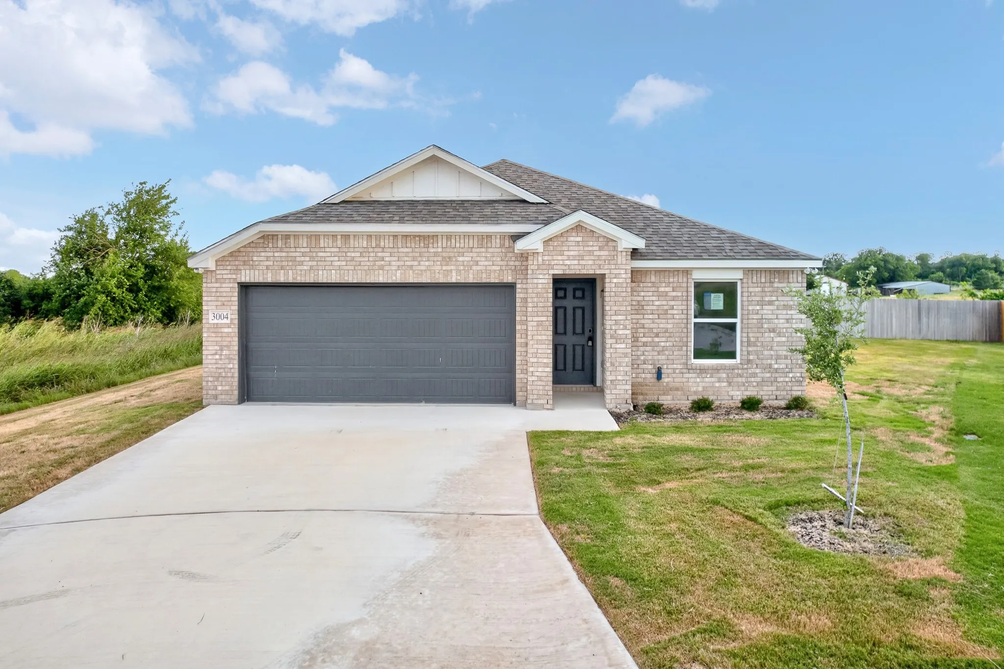 Brick exterior with a dark gray garage door