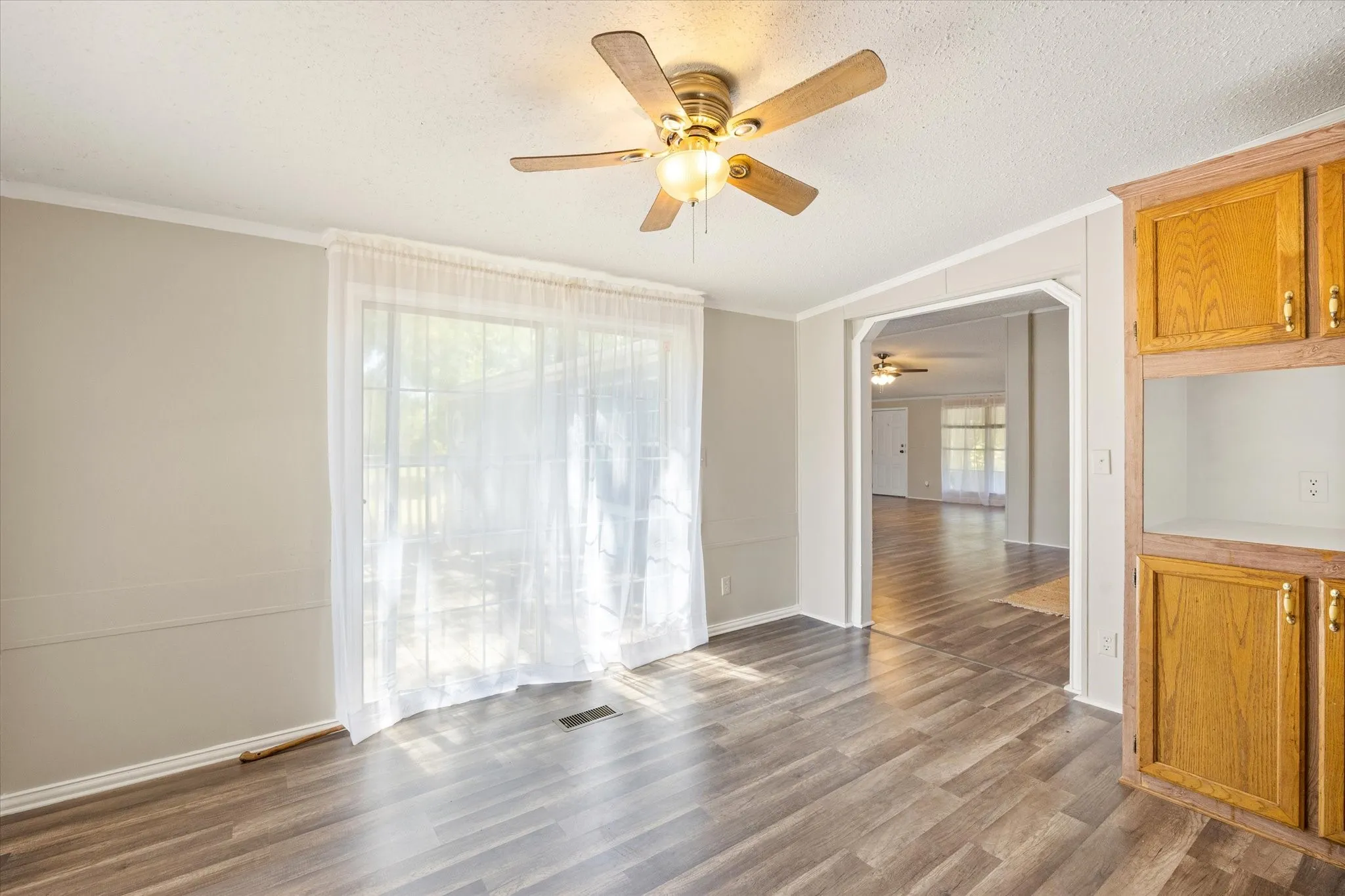 Breakfast nook area in kitchen by sliding glass door to the deck out back