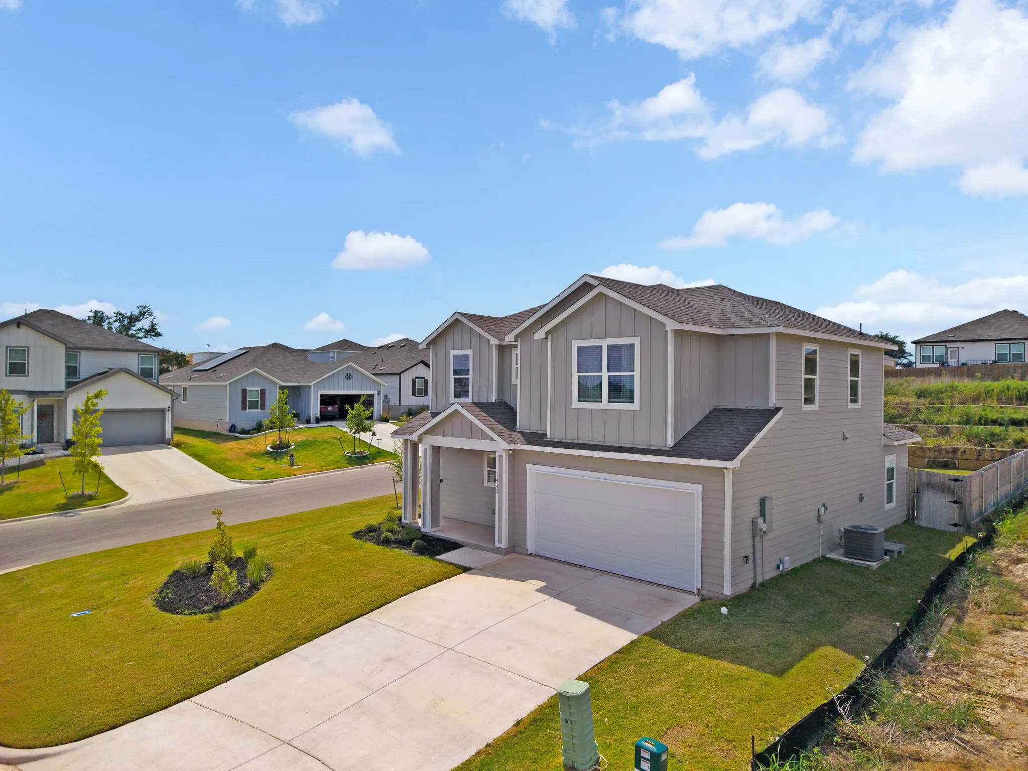 Two-story exterior with light gray siding and white trim accents