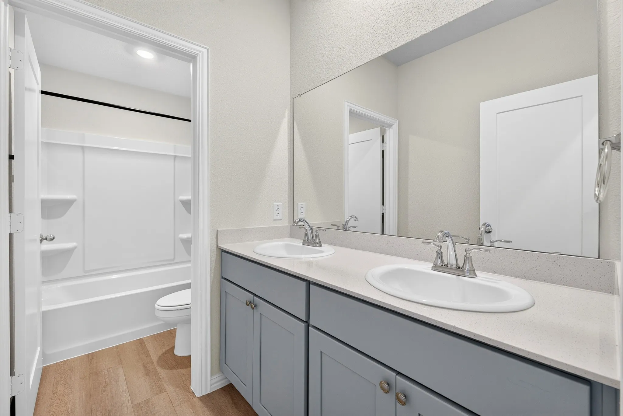Dual vanity with gray cabinetry and light-toned countertops