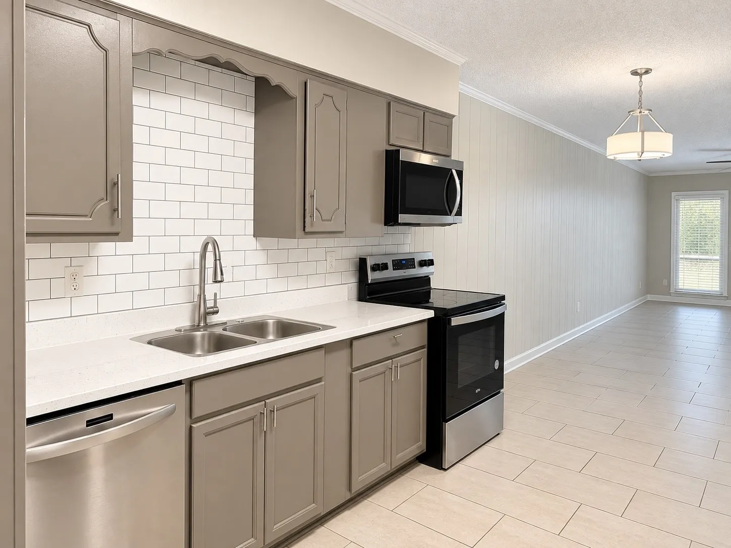 Kitchen featuring stainless steel appliances, dual basin sink, white subway tile backsplash