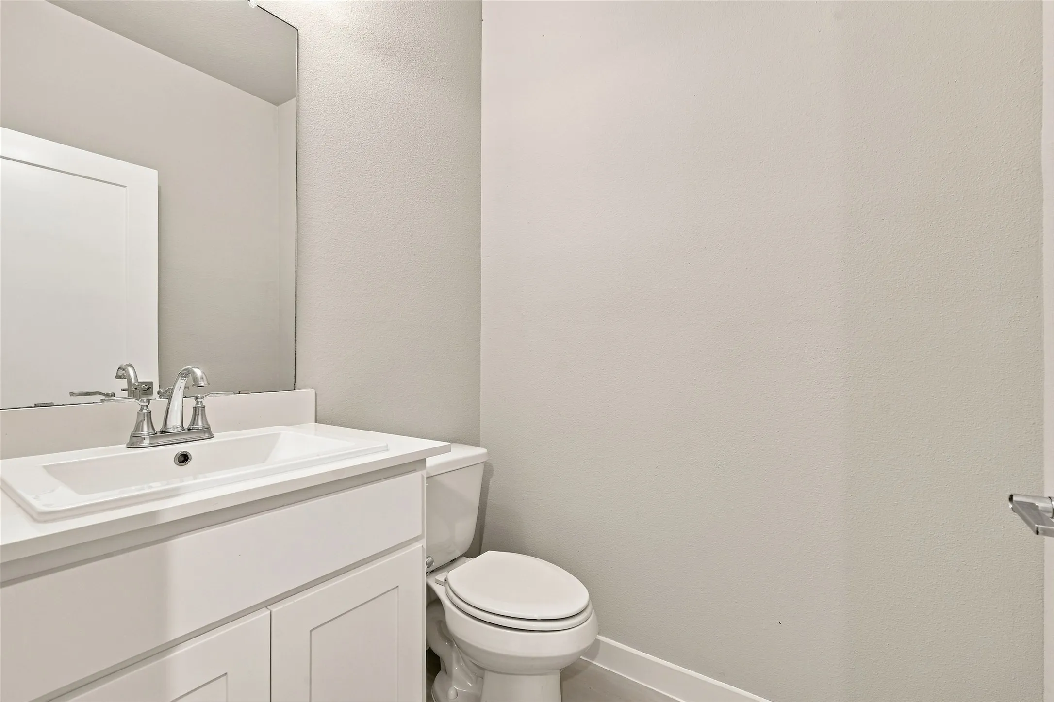 White vanity with an integrated sink and chrome faucet