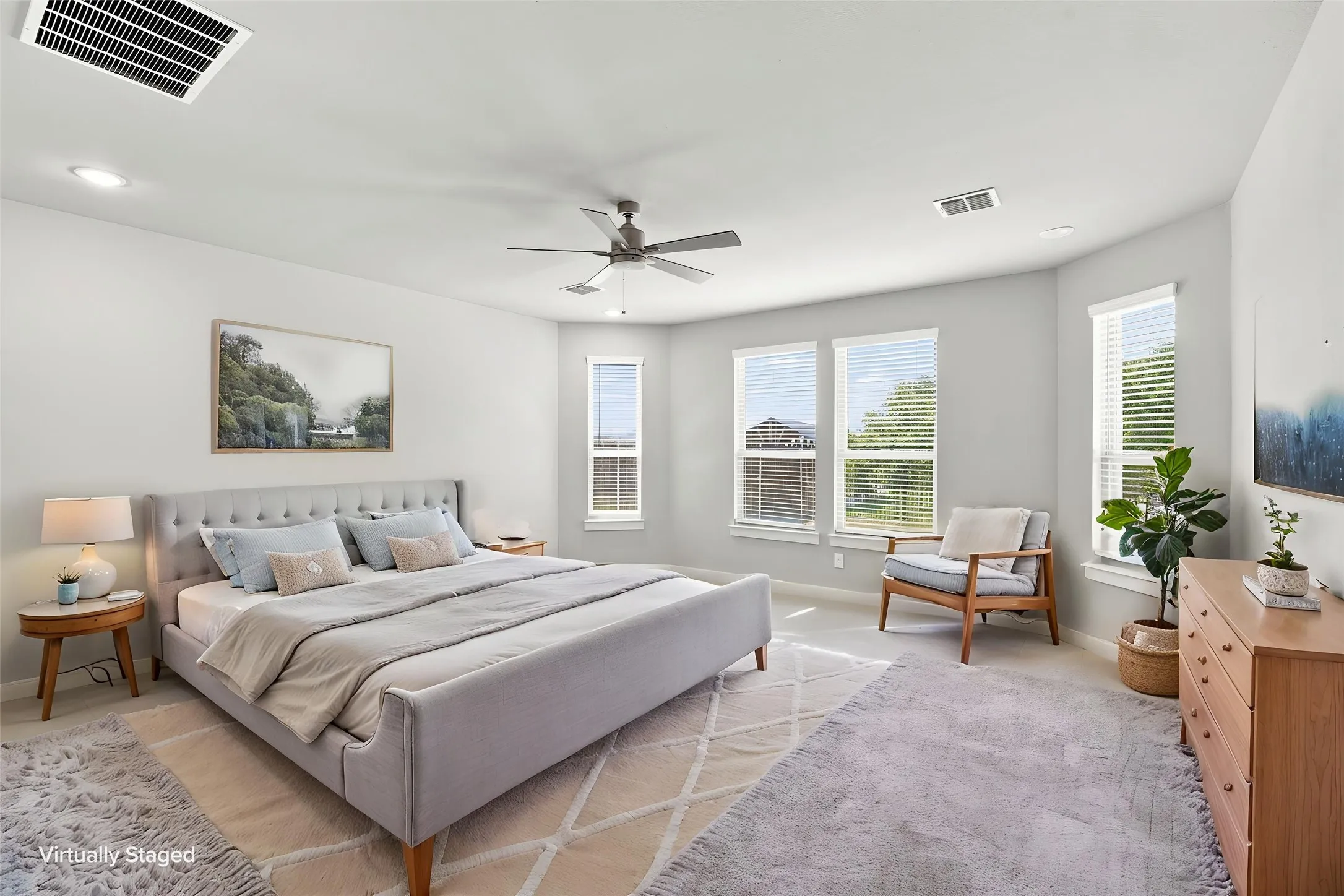 Spacious room featuring multiple large windows, recessed lighting, and a ceiling fan