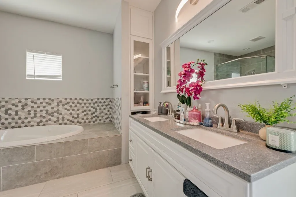 Dual vanity with integrated sinks and a stone-finish countertop