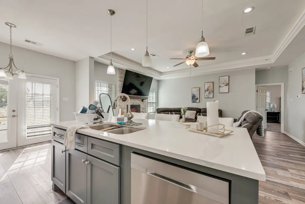 Spacious kitchen island with an undermount double-basin sink and stainless steel dishwasher