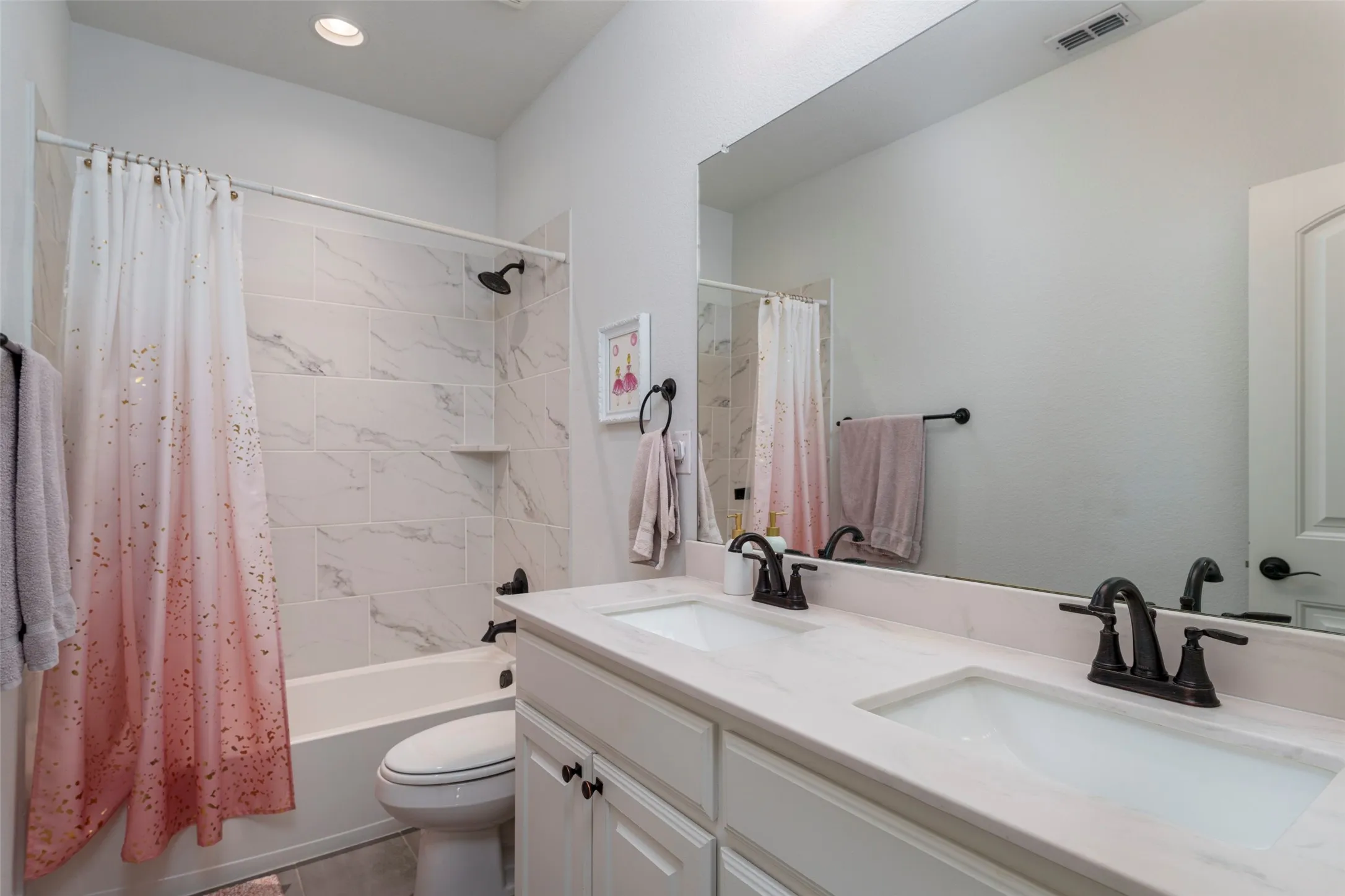 Another secondary bathroom with two sinks.