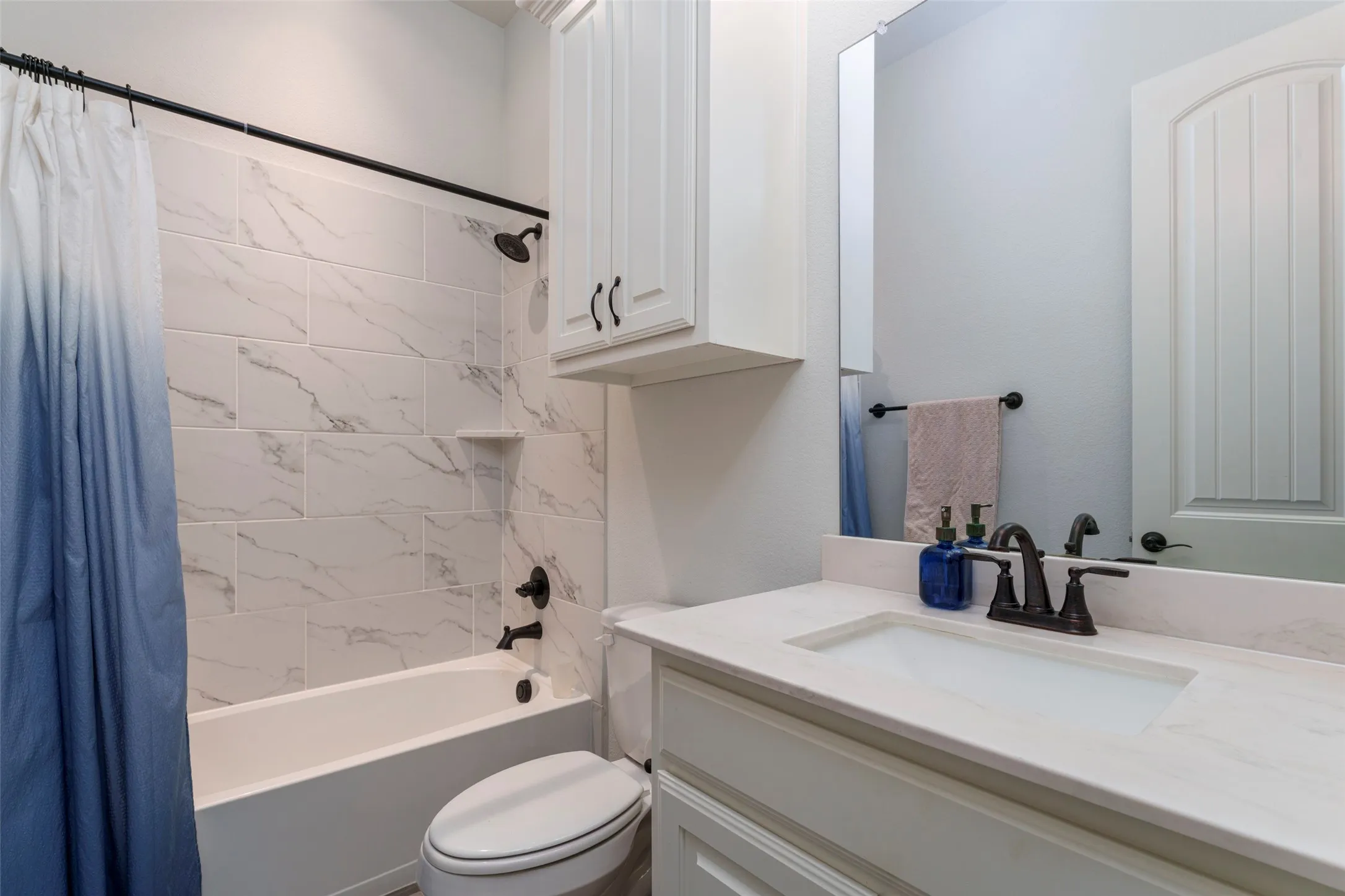 Secondary bathroom with beautiful tile backsplash.
