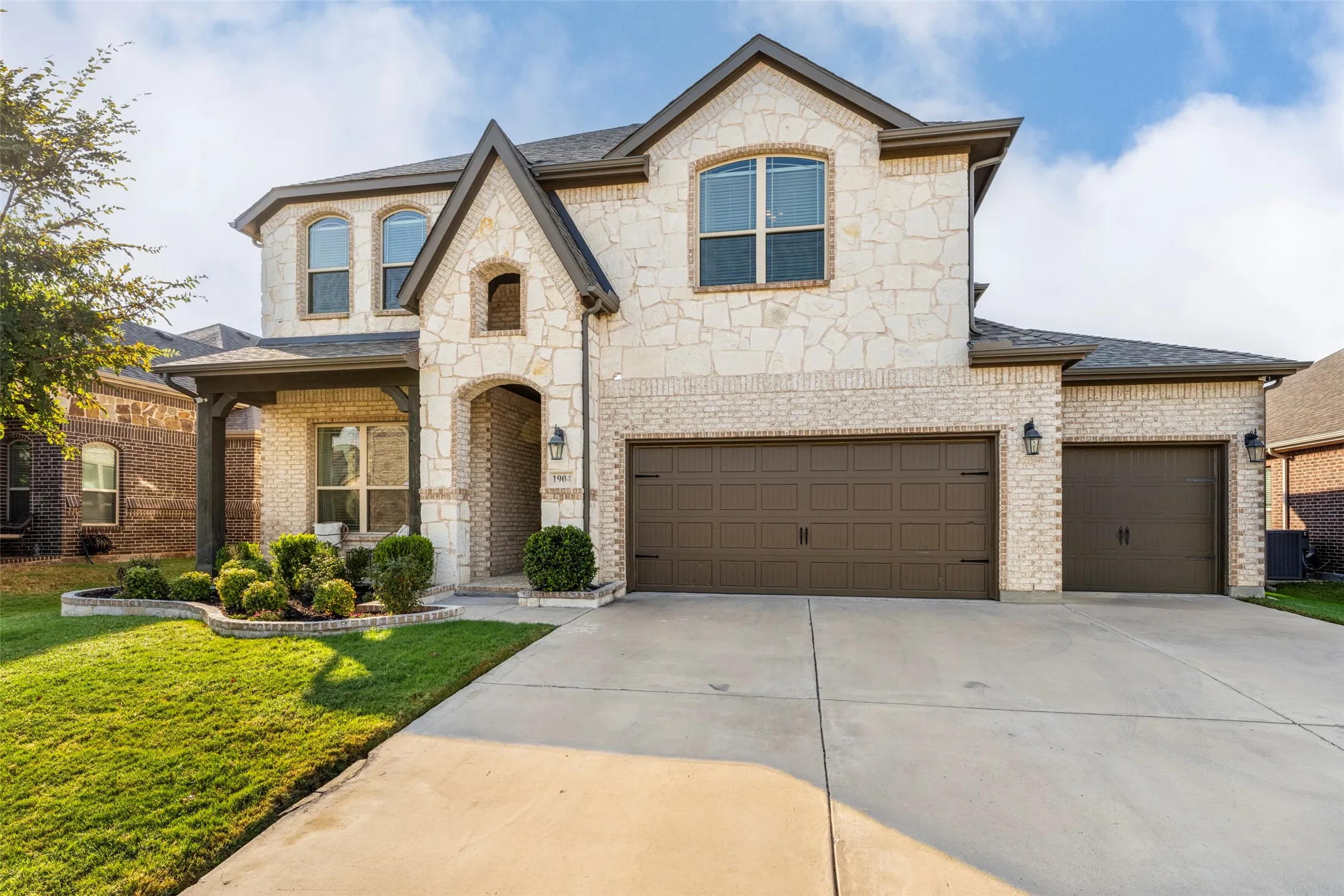 Three-car garage is ready for your vehicles and toys.