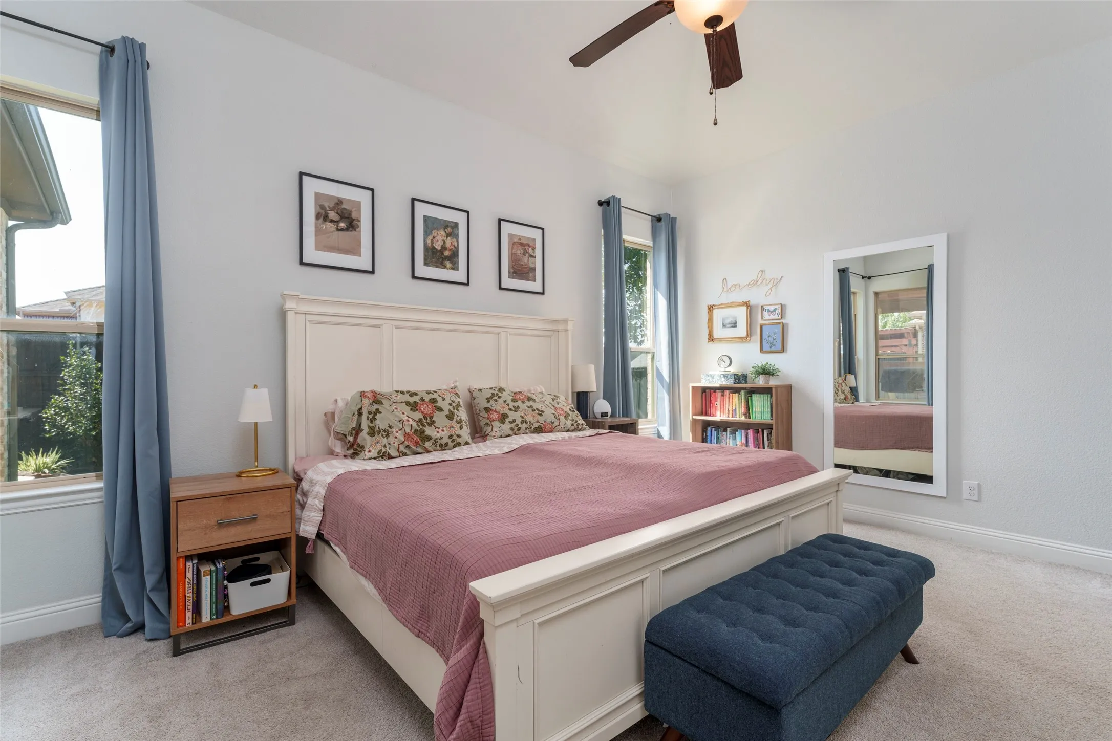 Very large primary bedroom with space for a king and end tables.