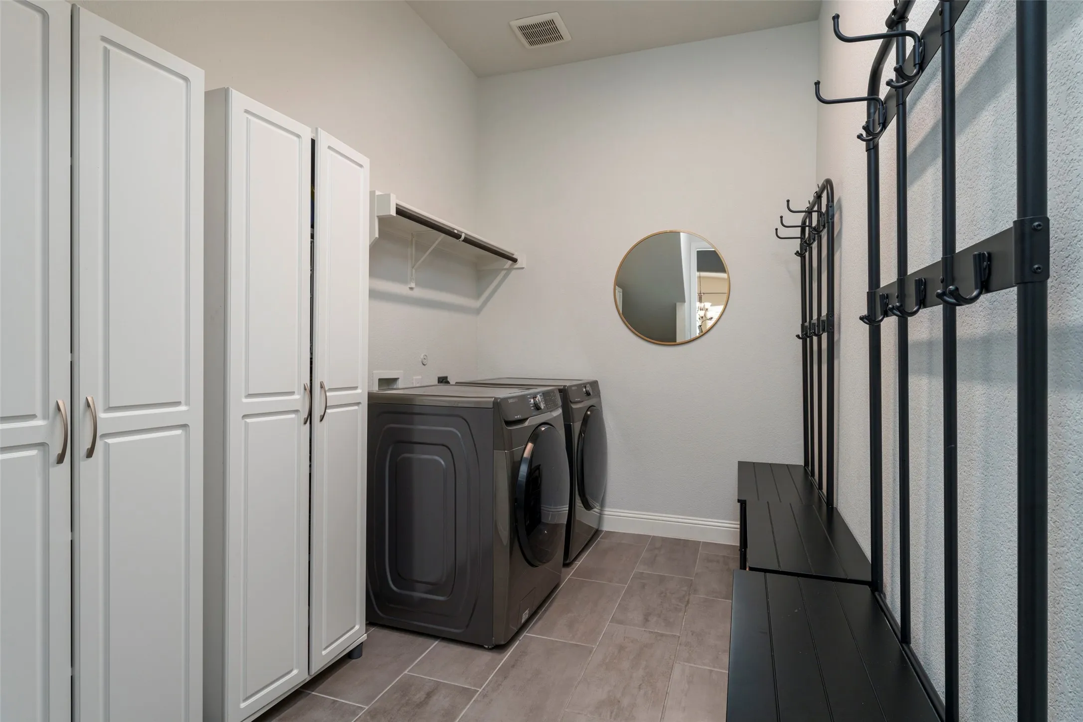 Laundry room is huge and large enough for cabinets and mud benches.