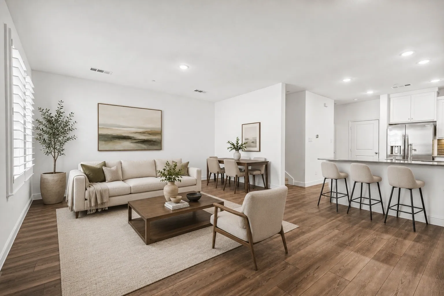 Open Concept Living Space Features Luxury Vinyl-Plank Flooring and Plantation Shutters