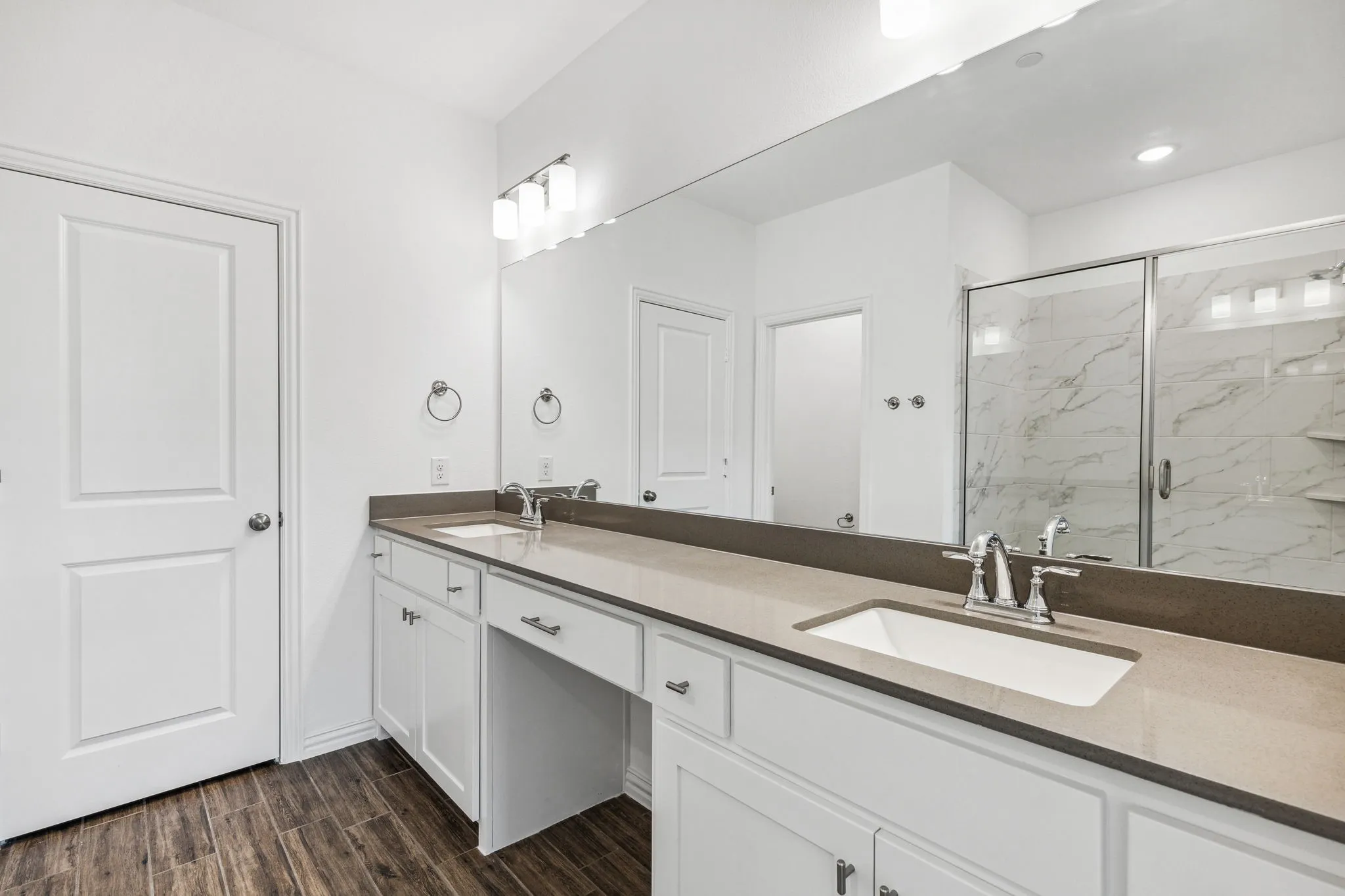 Primary Bath Boasts Gorgeous Wood-look Tile Flooring, Quartz Countertops, Vanity, and Double Sinks