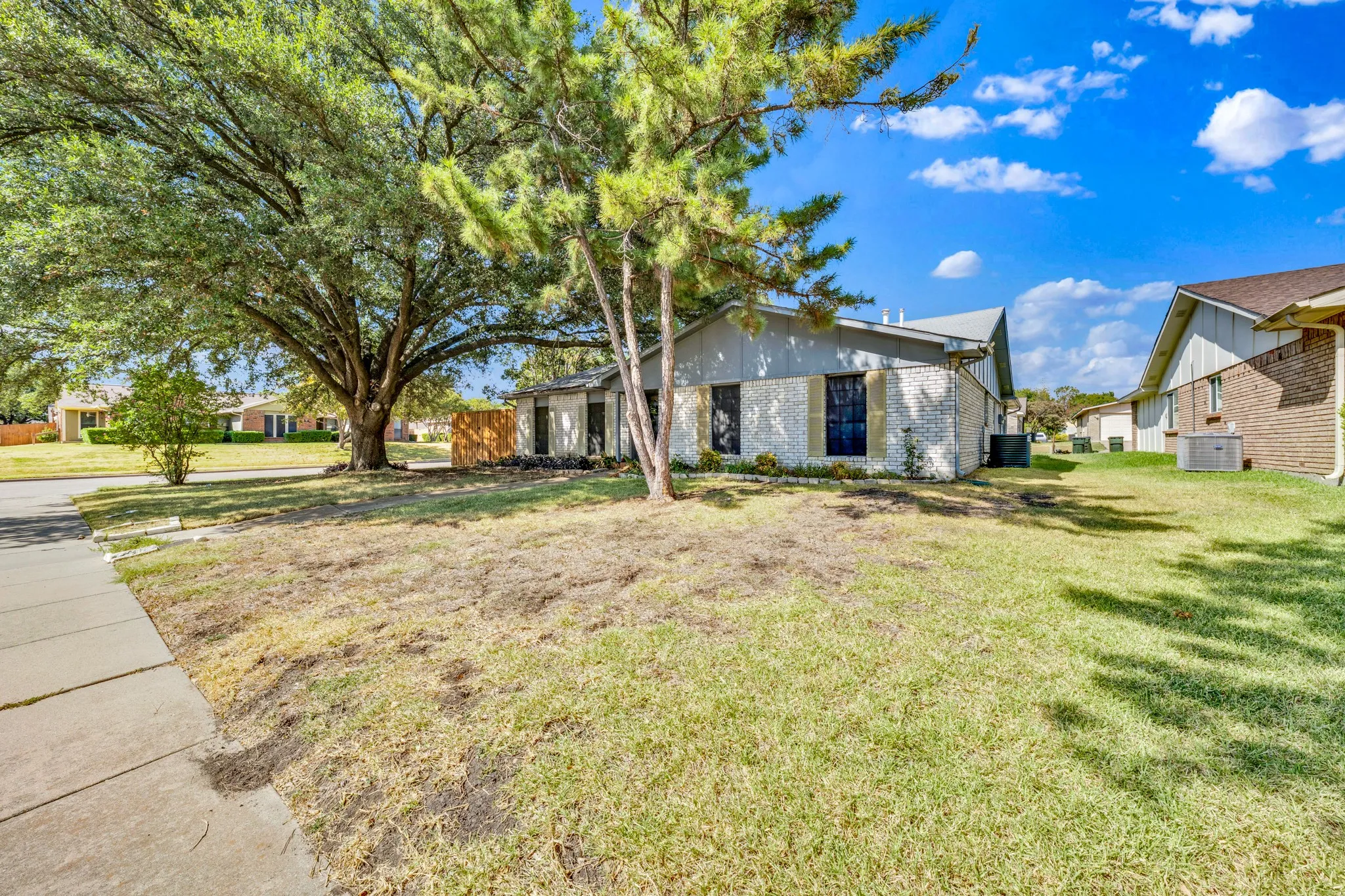 Mature trees provide ample shade to the front lawn