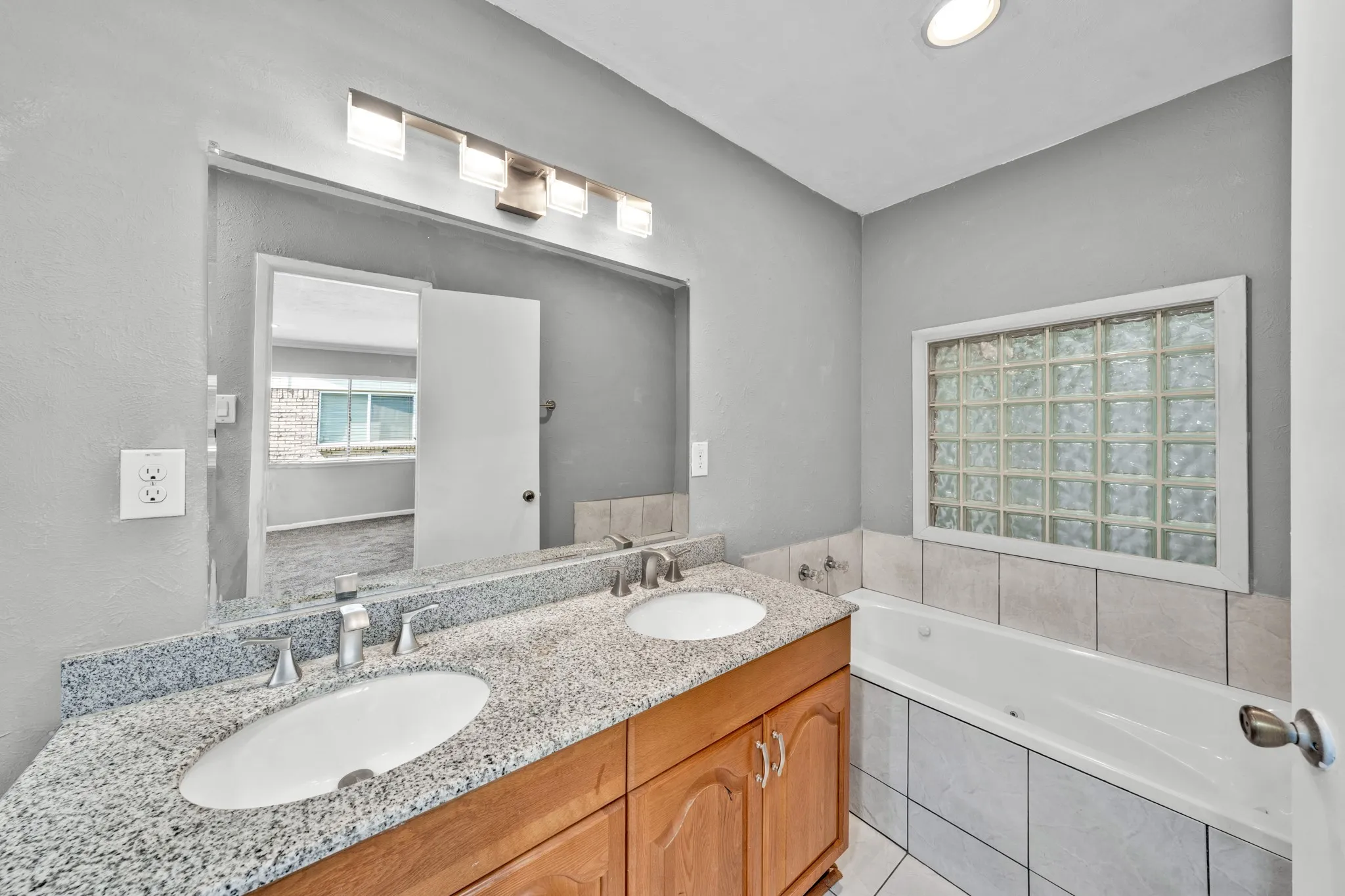 Dual vanity with light-toned countertop and undermount sinks