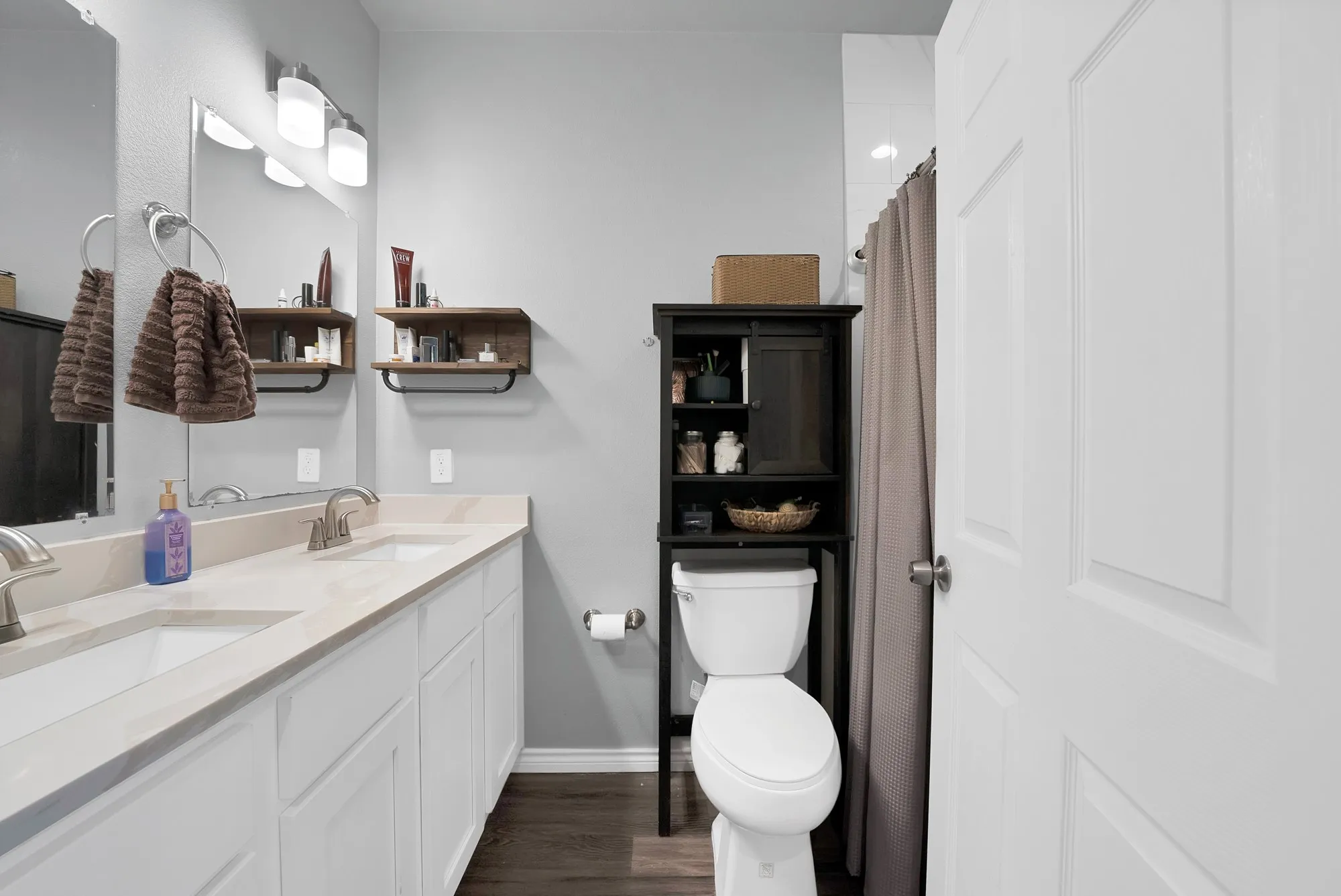 Dual vanity with undermount sinks, brushed nickel faucets, and a light-toned countertop