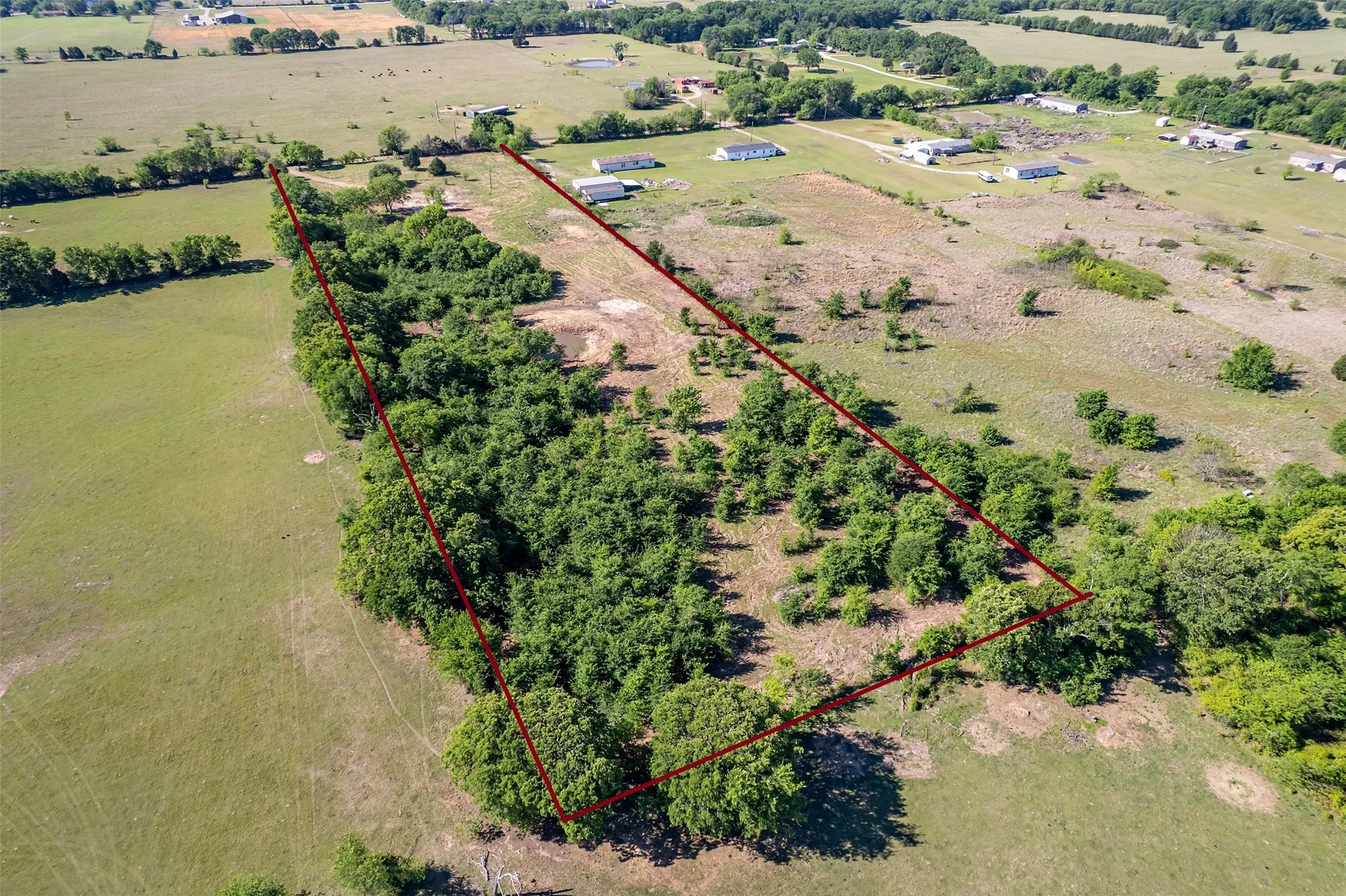 Expansive parcel featuring mature trees, open land, and undeveloped acreage